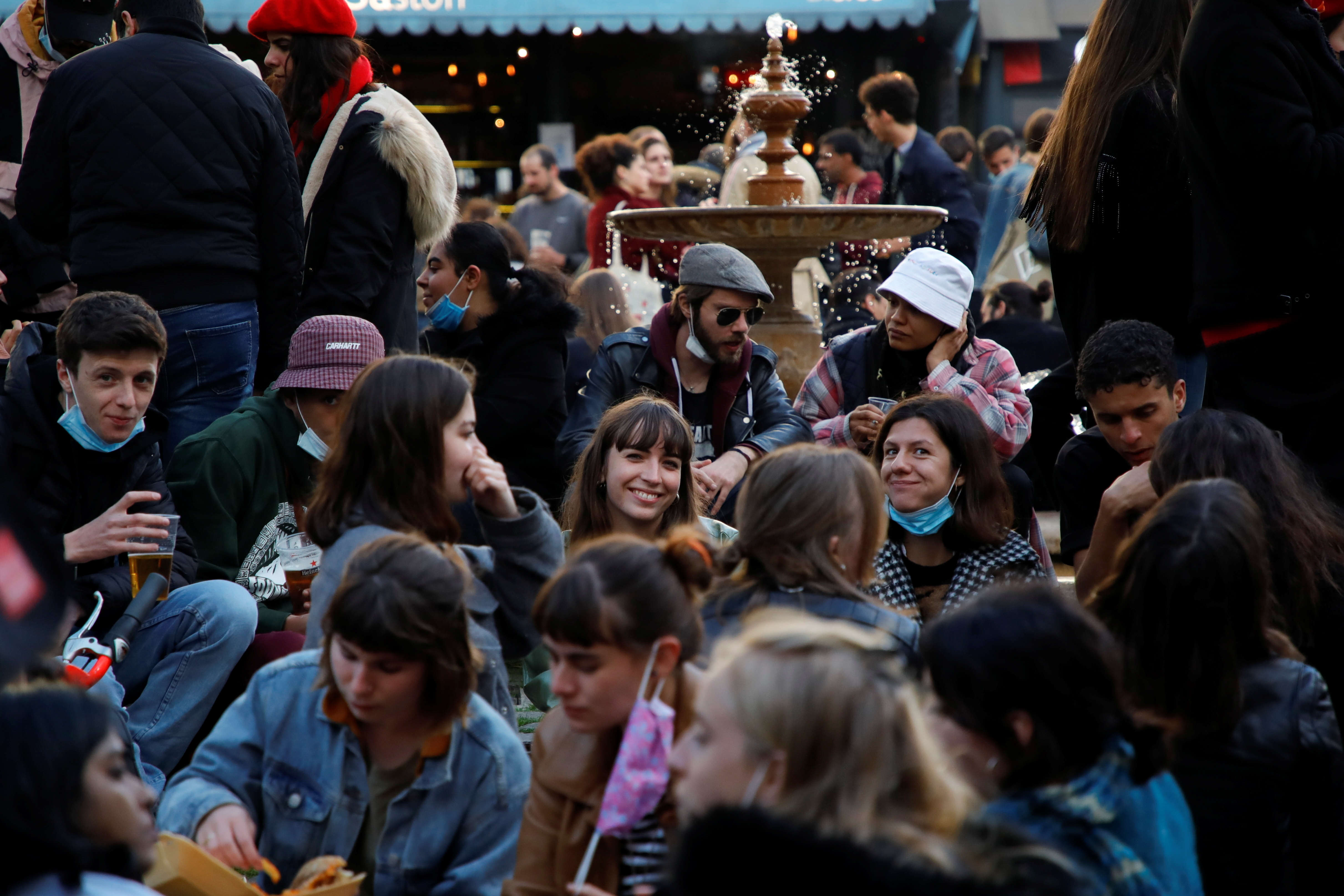 People enjoy an evening drink at Place de la Contrescarpe in Paris as cafes, bars and restaurants reopen after closing down for months amid the coronavirus disease (COVID-19) outbreak in France, May 19, 2021. REUTERS/Sarah Meyssonnier