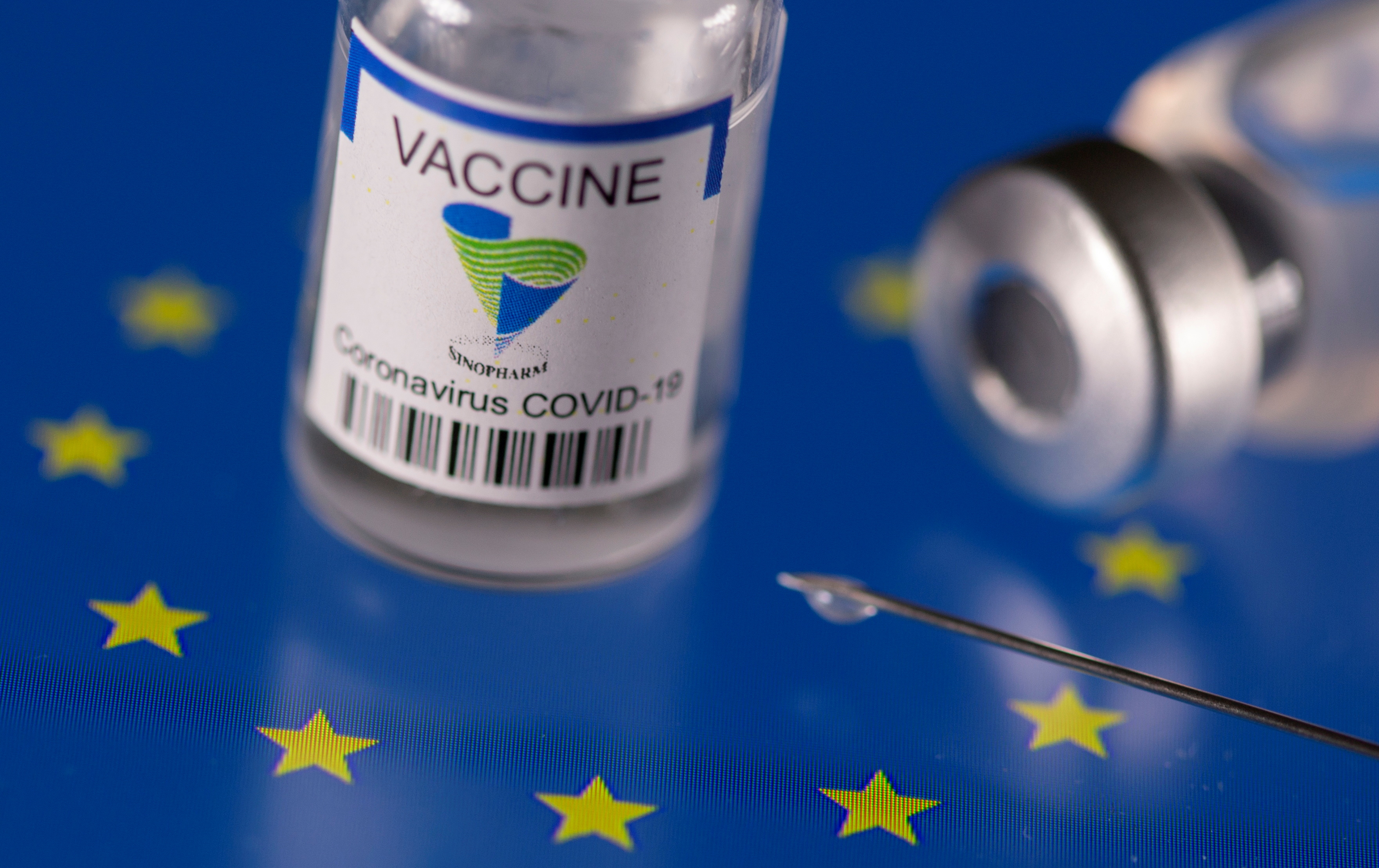 FILE PHOTO: Vials labelled "Sinopharm coronavirus disease (COVID-19) vaccine" placed on displayed EU flag are seen in this illustration picture taken March 24, 2021. REUTERS/Dado Ruvic/Illustration/File Photo
