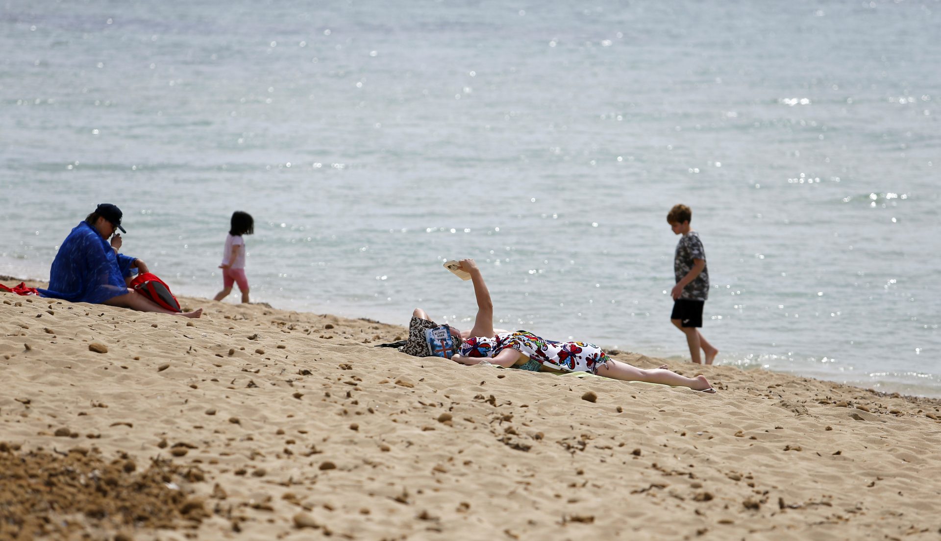People sunbathe and chill in Playa de Palma beach in Palma de Mallorca, ahead of Easter celebrations, Spain, April 1, 2021. REUTERS/Enrique Calvo