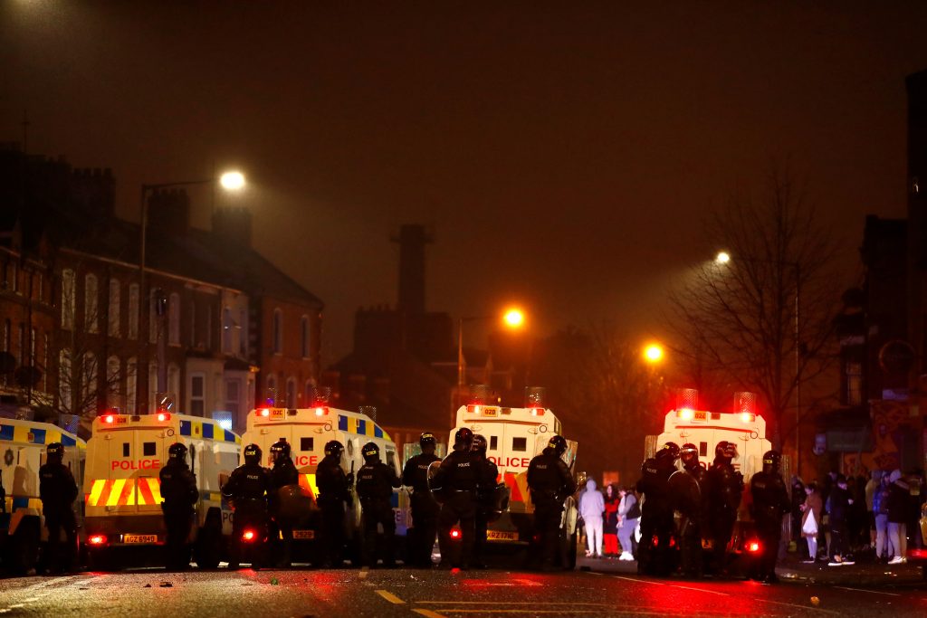 Police officers stand near their vehicles during a riot at Lanark Way as protests continue in Belfast, Northern Ireland, April 7, 2021. REUTERS/Jason Cairnduff