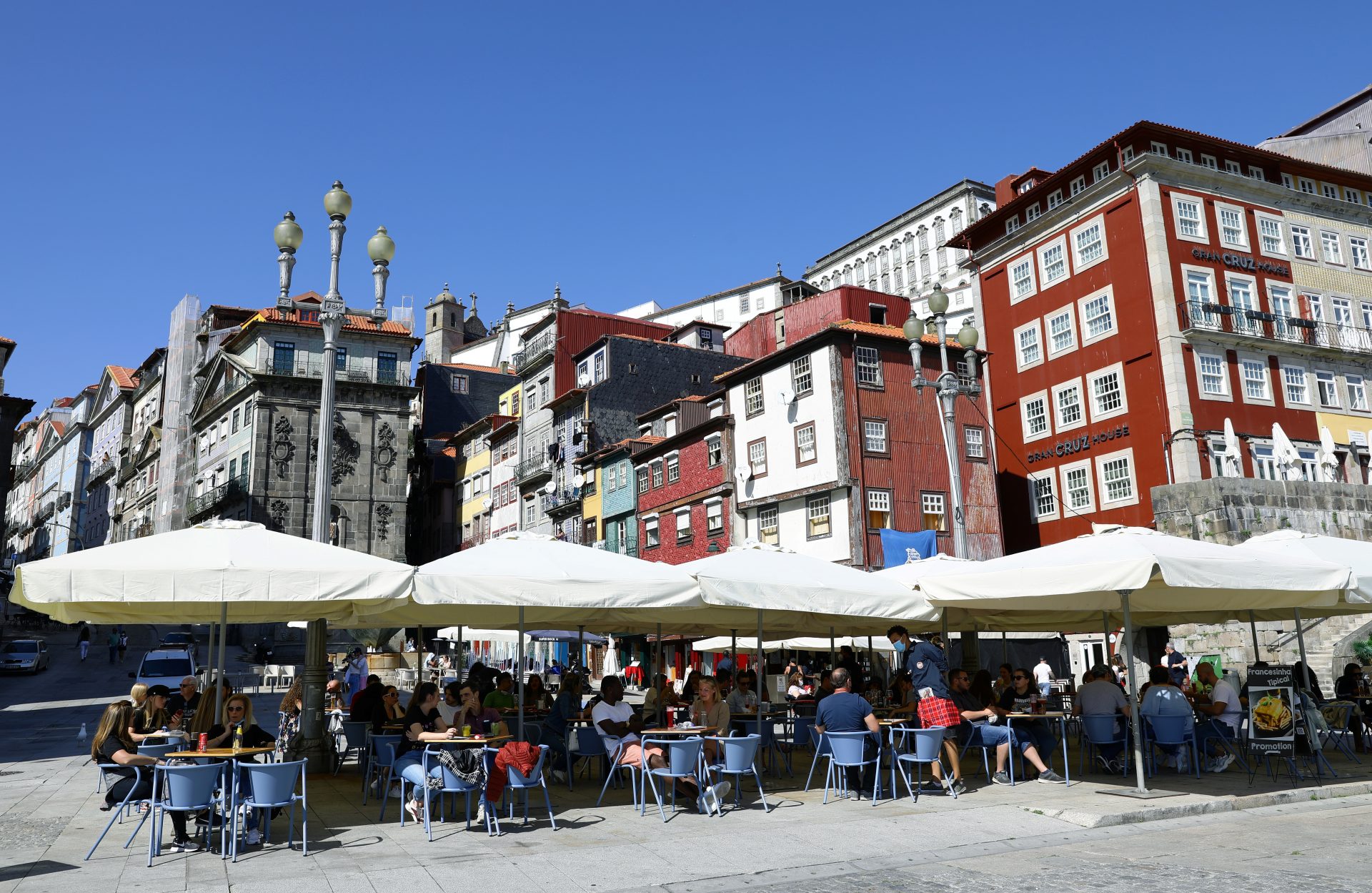People sit at a cafe terrace as the country eases the coronavirus disease (COVID-19) restrictions, in Porto, Portugal, April 5, 2021. REUTERS/Violeta Santos Moura