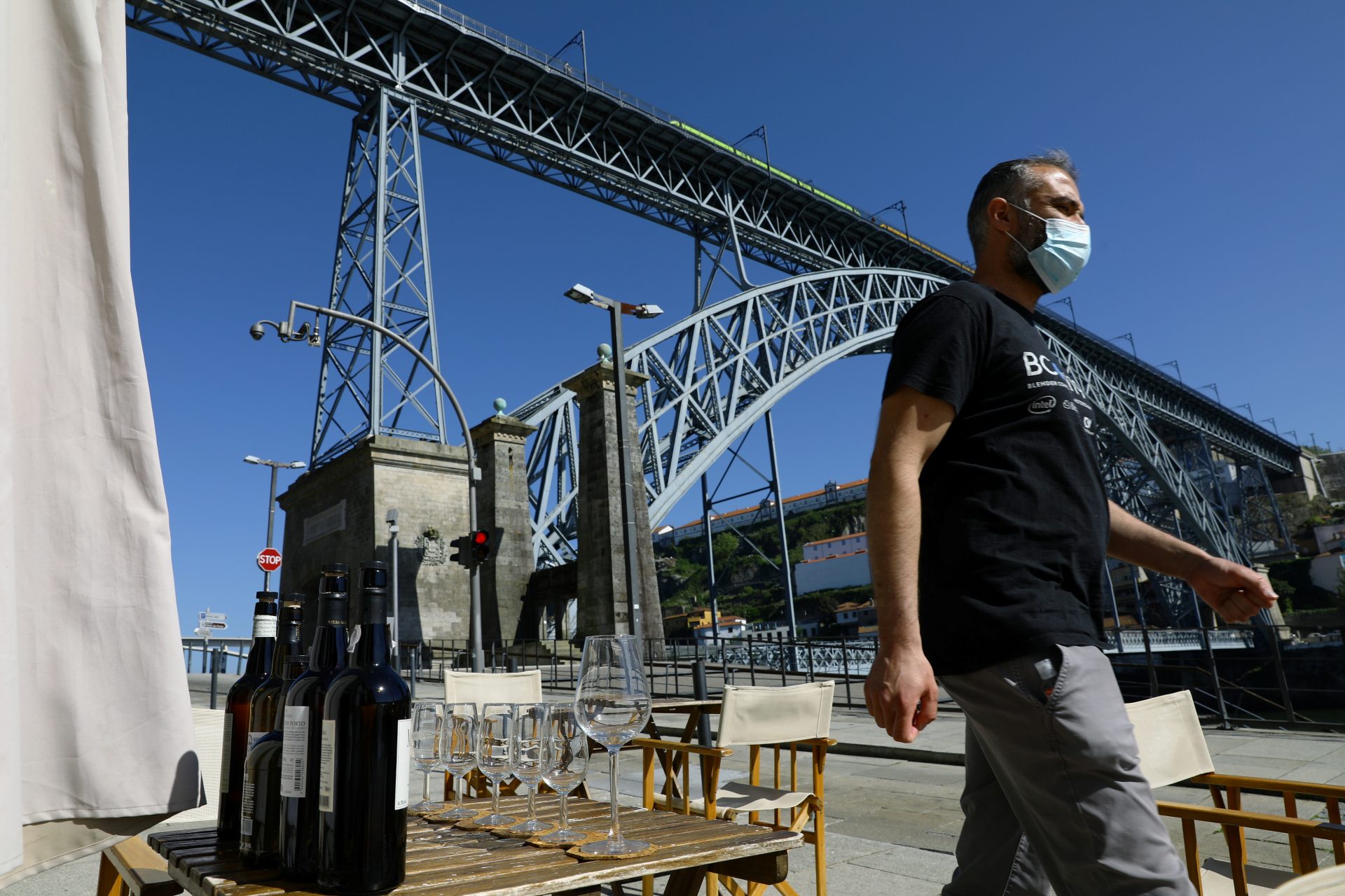 A man walks past a cafe terrace as the country eases the coronavirus disease (COVID-19) restrictions, in Porto, Portugal, April 5, 2021. REUTERS/Violeta Santos Moura