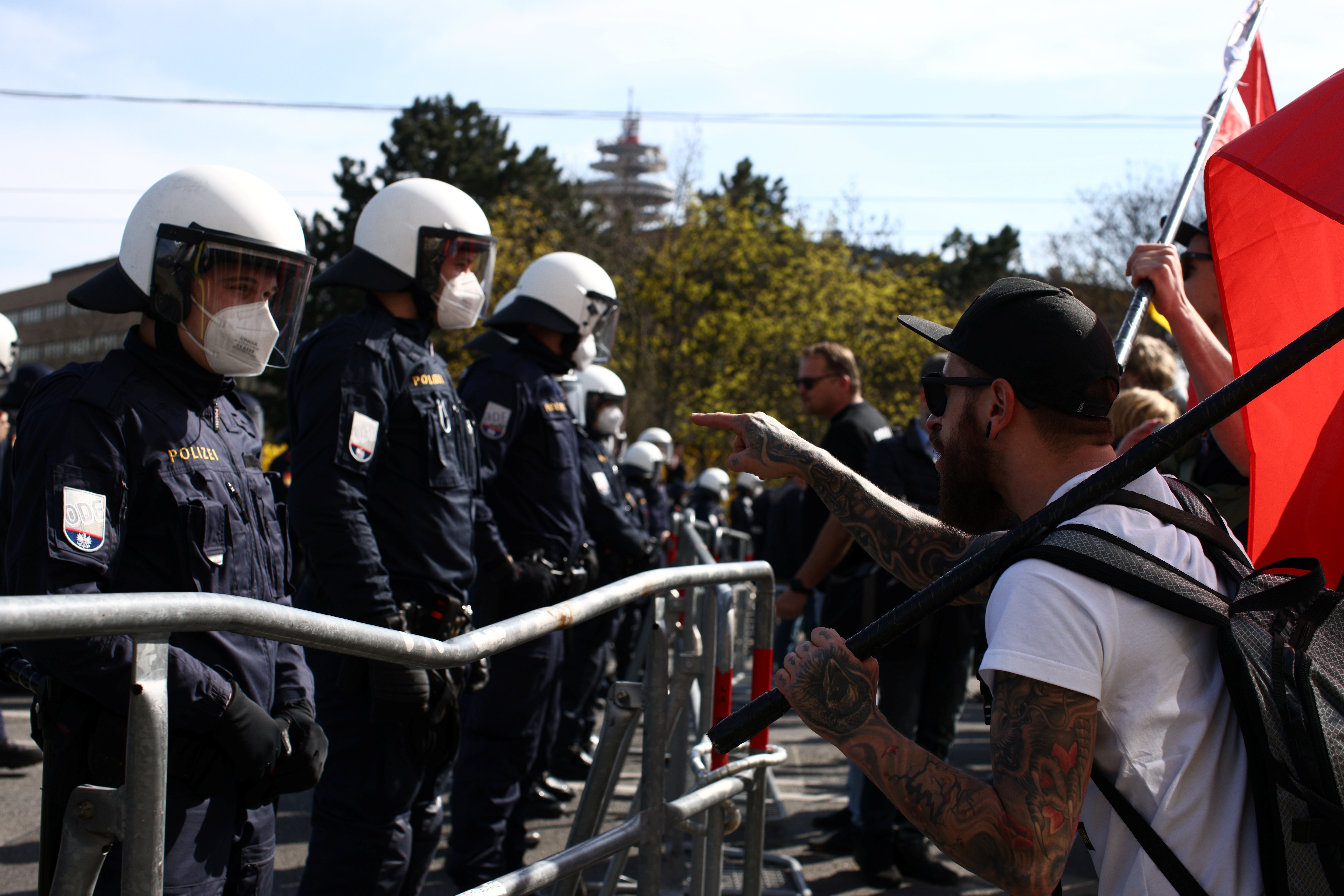 A demonstrator approaches police officers during a protest against the coronavirus disease (COVID-19) measures in Vienna, Austria, April 10, 2021. REUTERS/Lisi Niesner