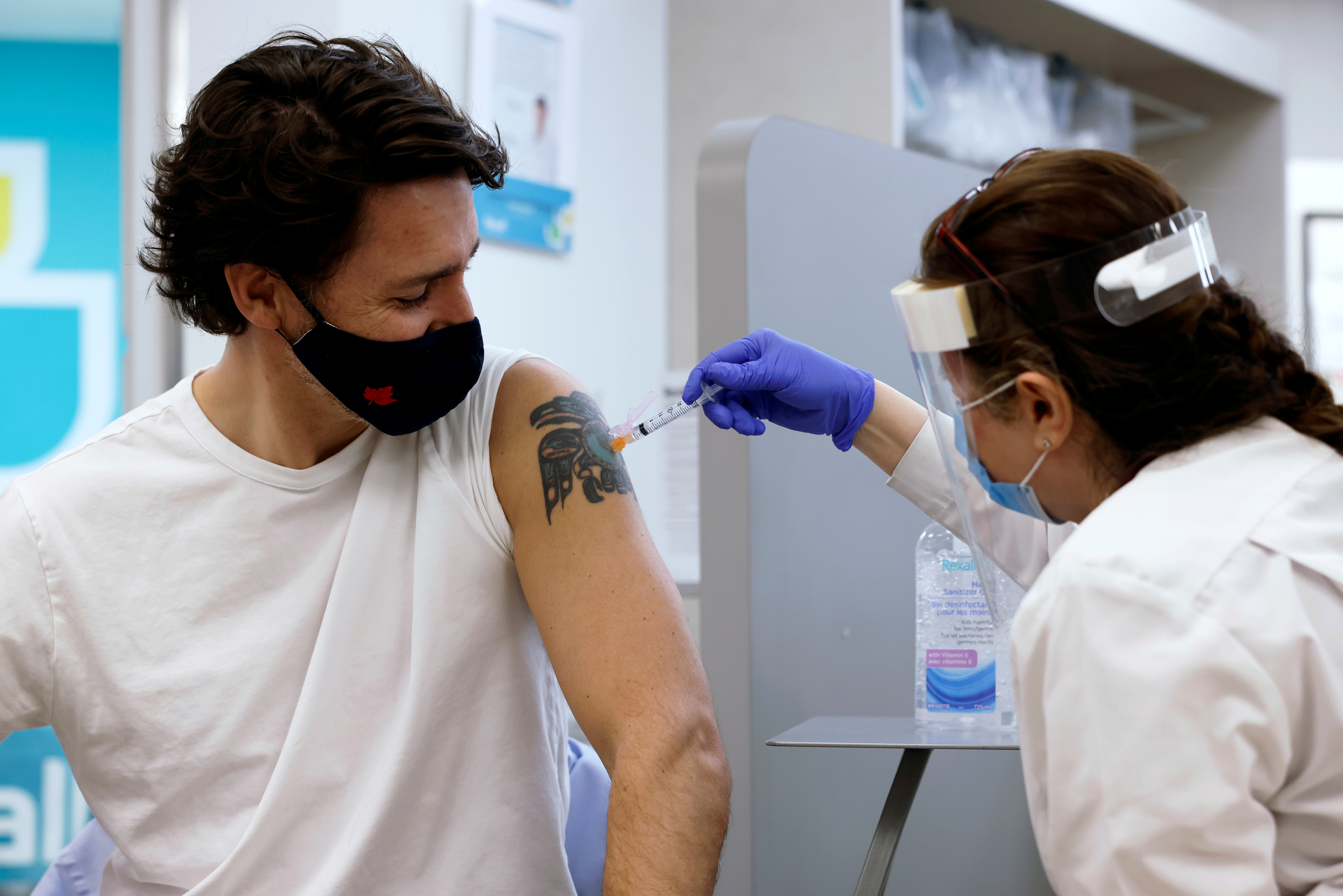 Canada's Prime Minister Justin Trudeau is inoculated with AstraZeneca's vaccine against coronavirus disease (COVID-19) at a pharmacy in Ottawa, Ontario, Canada April 23, 2021.   REUTERS/Blair Gable