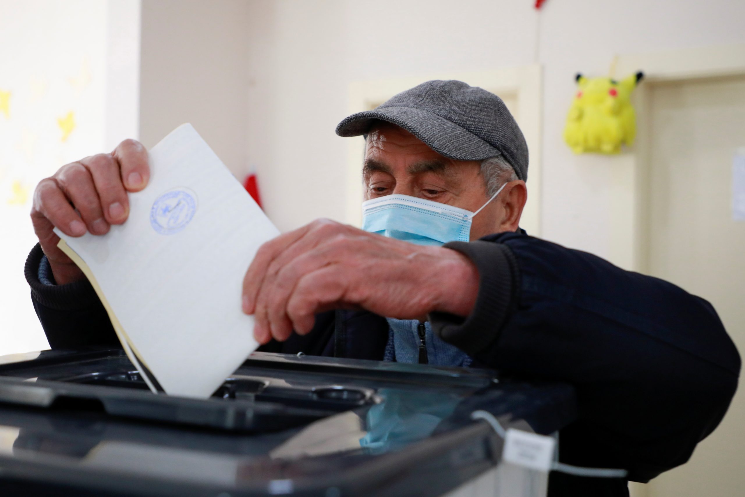 A voter casts his ballot during the parliamentary election, in Tirana, Albania April 25, 2021. REUTERS/Florion Goga