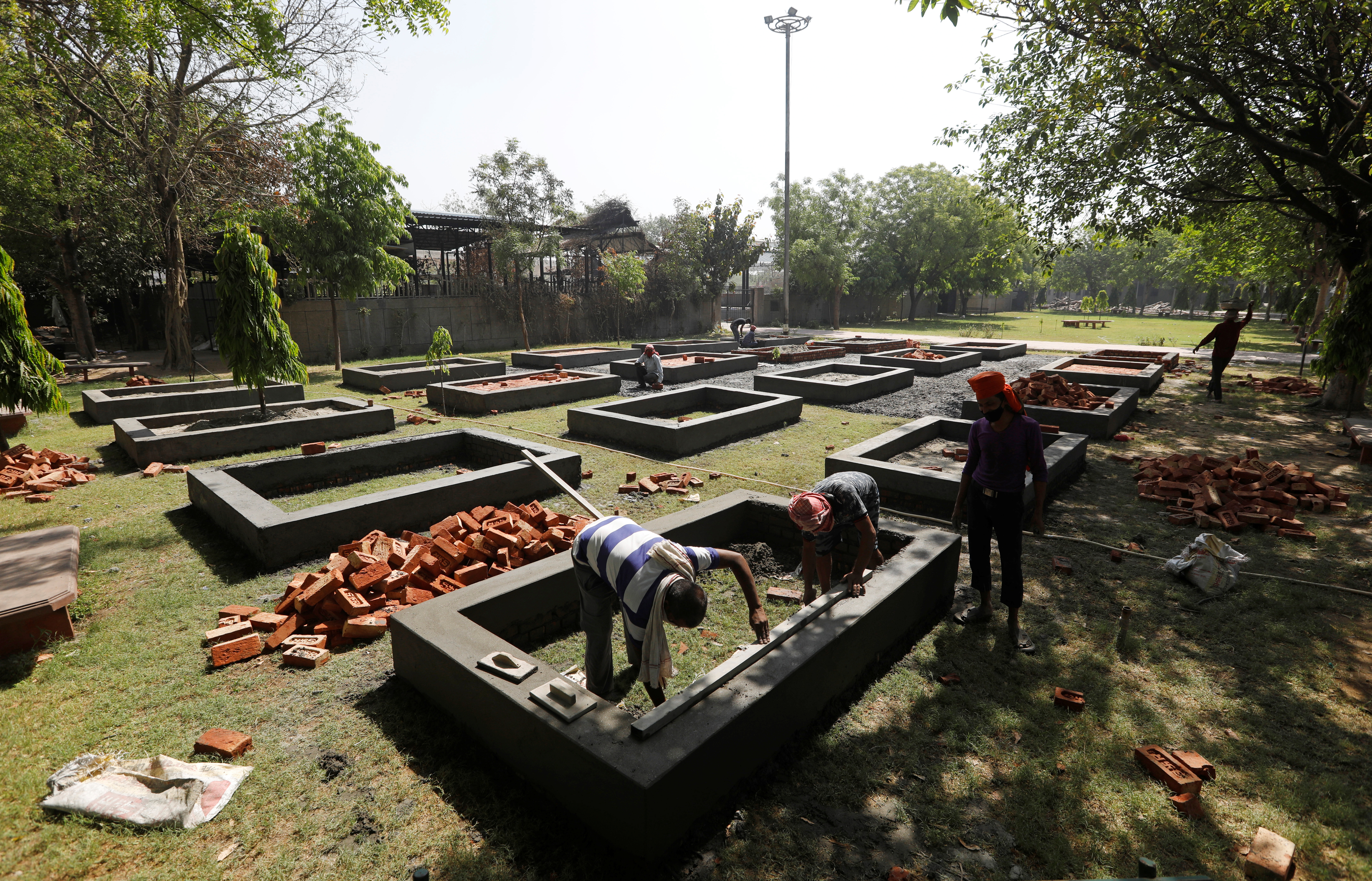 Workers build new platforms to cremate bodies inside a crematorium, amid the spread of the coronavirus disease (COVID-19) in New Delhi