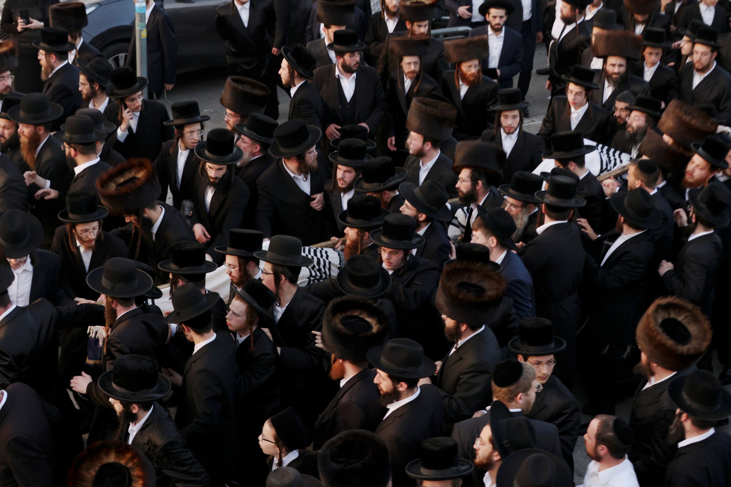 Ultra-Orthodox Jewish men mourn during the funeral of Moshe Engerld, 14, and his brother Yehushua, 12, who died during Lag B'Omer commemorations on Mount Meron,  in Jerusalem April 30, 2021. REUTERS/Ronen Zvulun