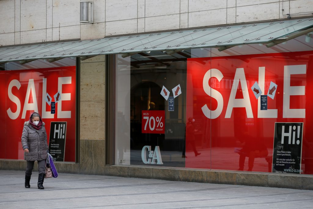A woman walks past a 'C&amp;A' store that is closed due to the coronavirus disease (COVID-19) pandemic in Munich, Germany, February 5, 2021. Picture taken February 5, 2021. REUTERS/Michaela Rehle