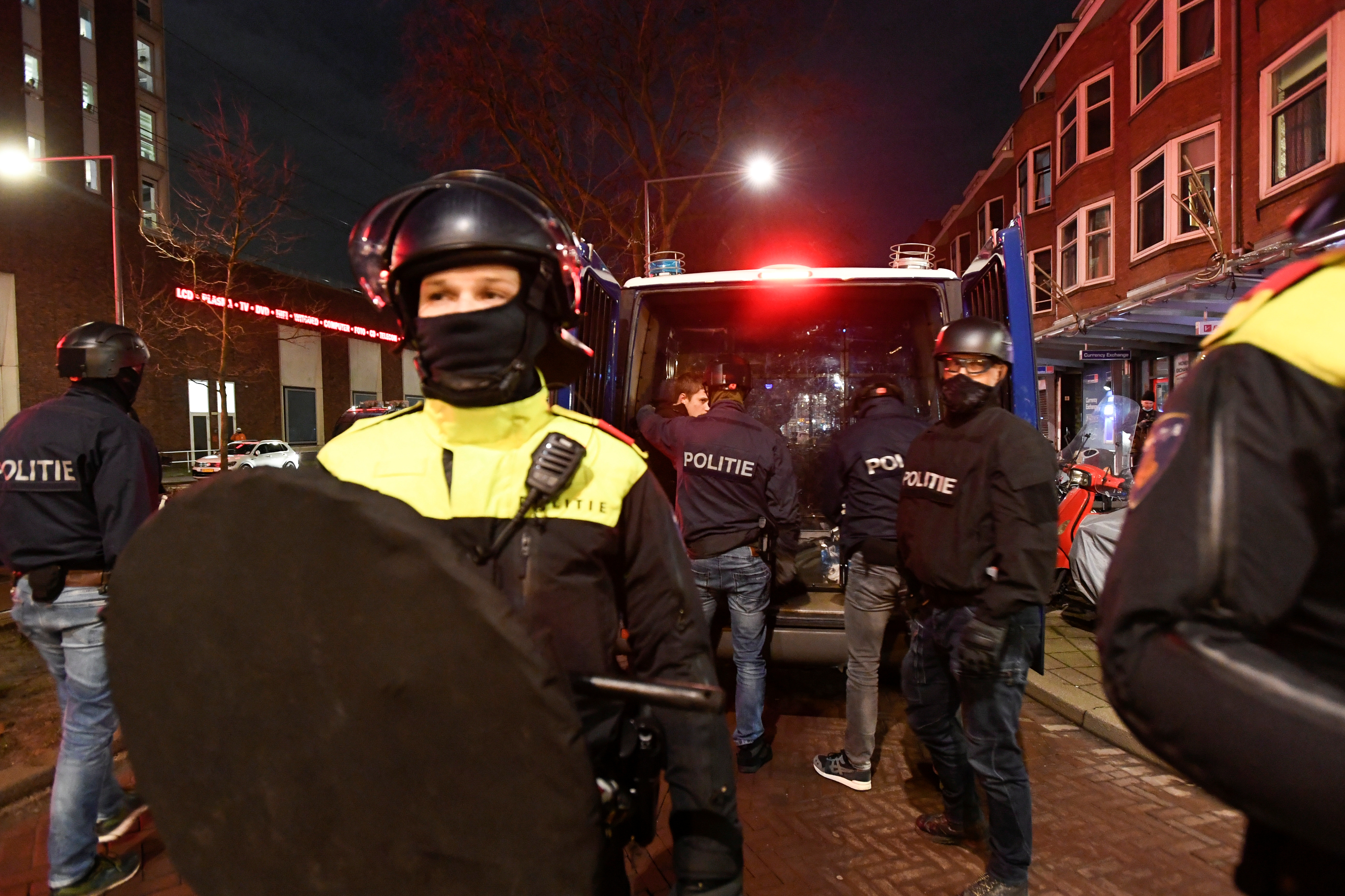 Police officers prepare for a protest against restrictions put in place to curb the spread of the coronavirus disease (COVID-19) in Rotterdam, Netherlands, January 26, 2021. REUTERS/Stringer