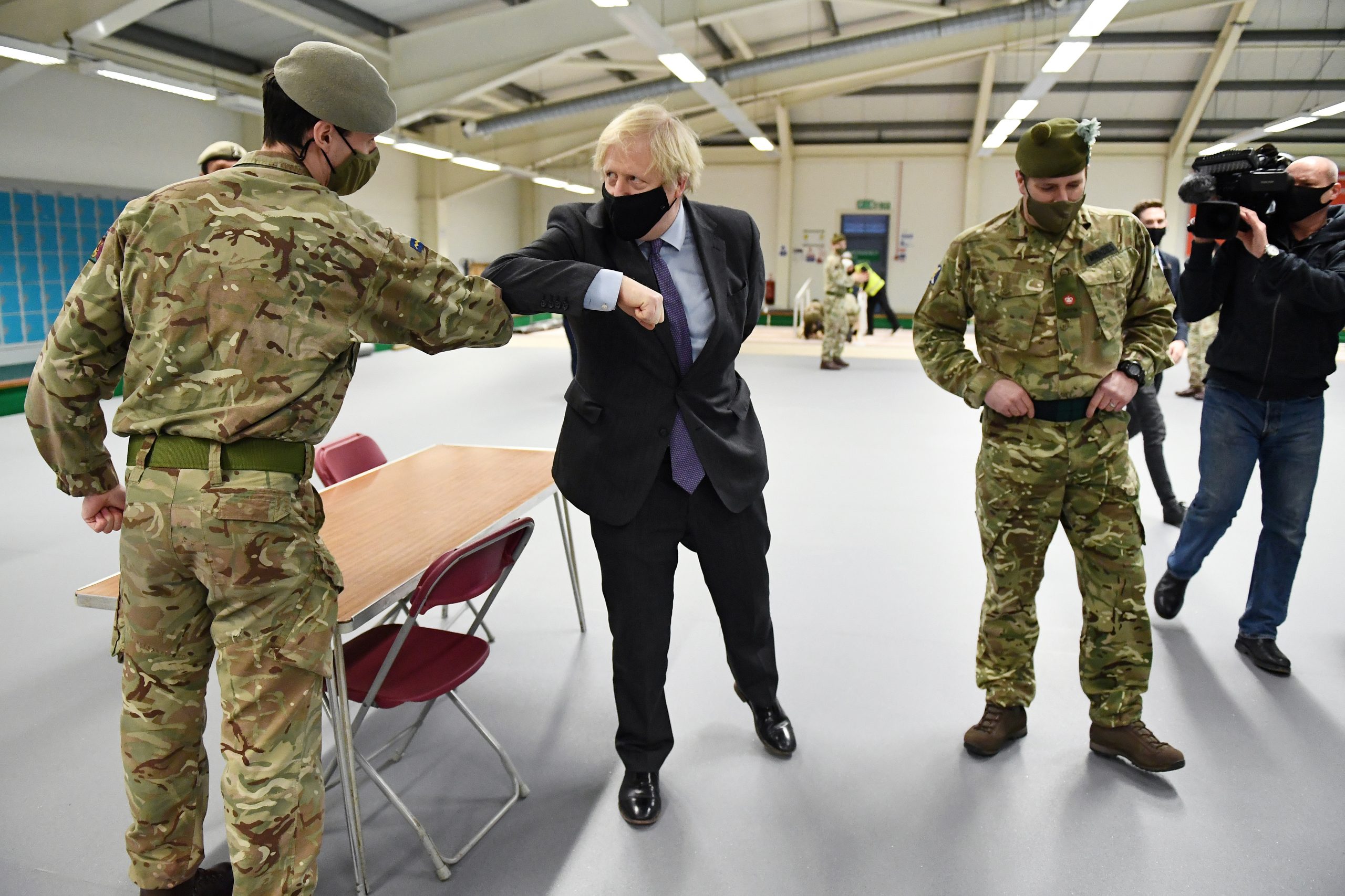 British Prime Minister Boris Johnson meets troops as they set up a vaccination centre in the Castlemilk district of Glasgow, Scotland, Britain January 28, 2021. Jeff J Mitchell/Pool via REUTERS