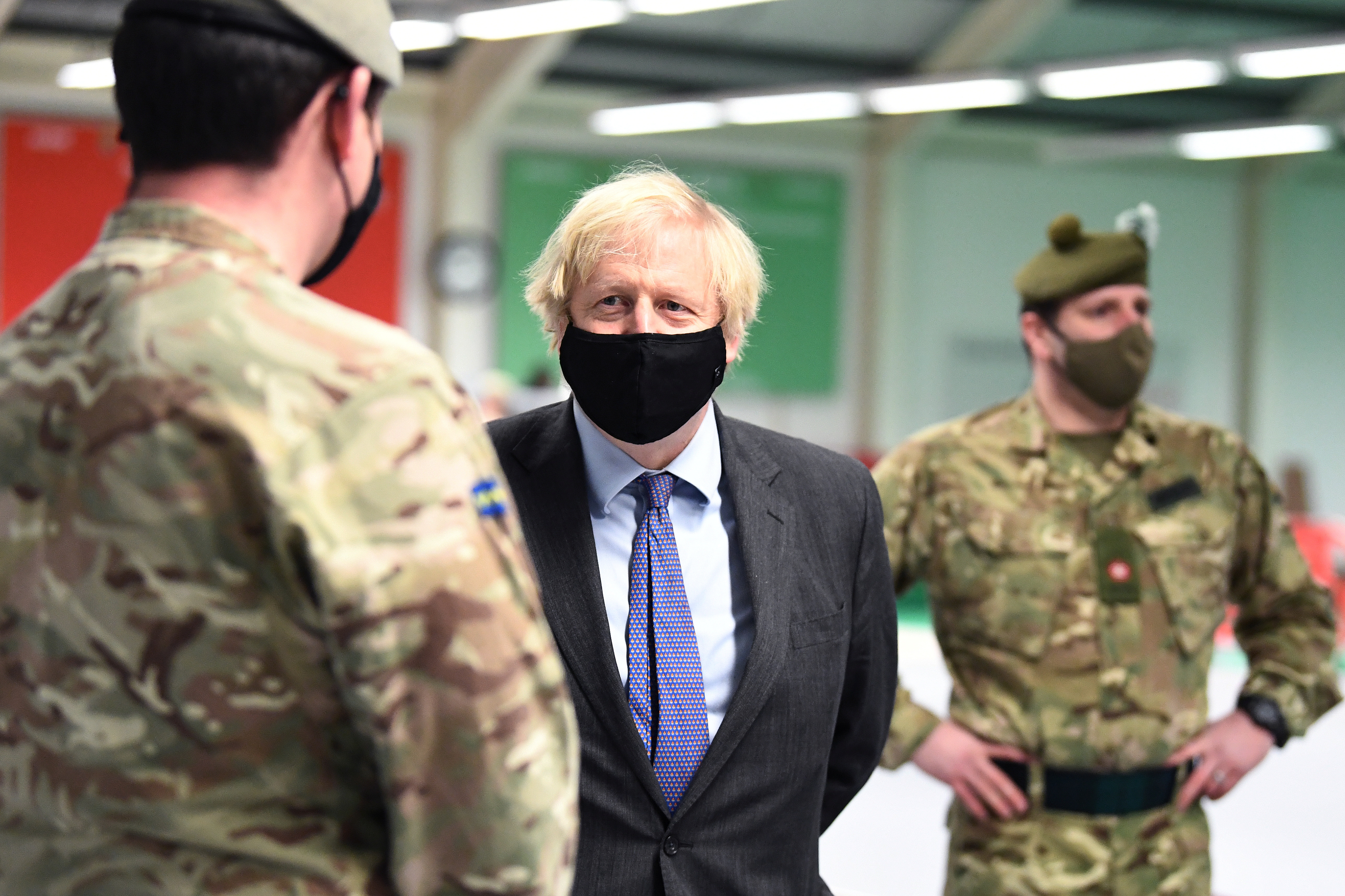 British Prime Minister Boris Johnson meets troops as they set up a vaccination centre in the Castlemilk district of Glasgow, Scotland, Britain January 28, 2021. Jeff J Mitchell/Pool via REUTERS