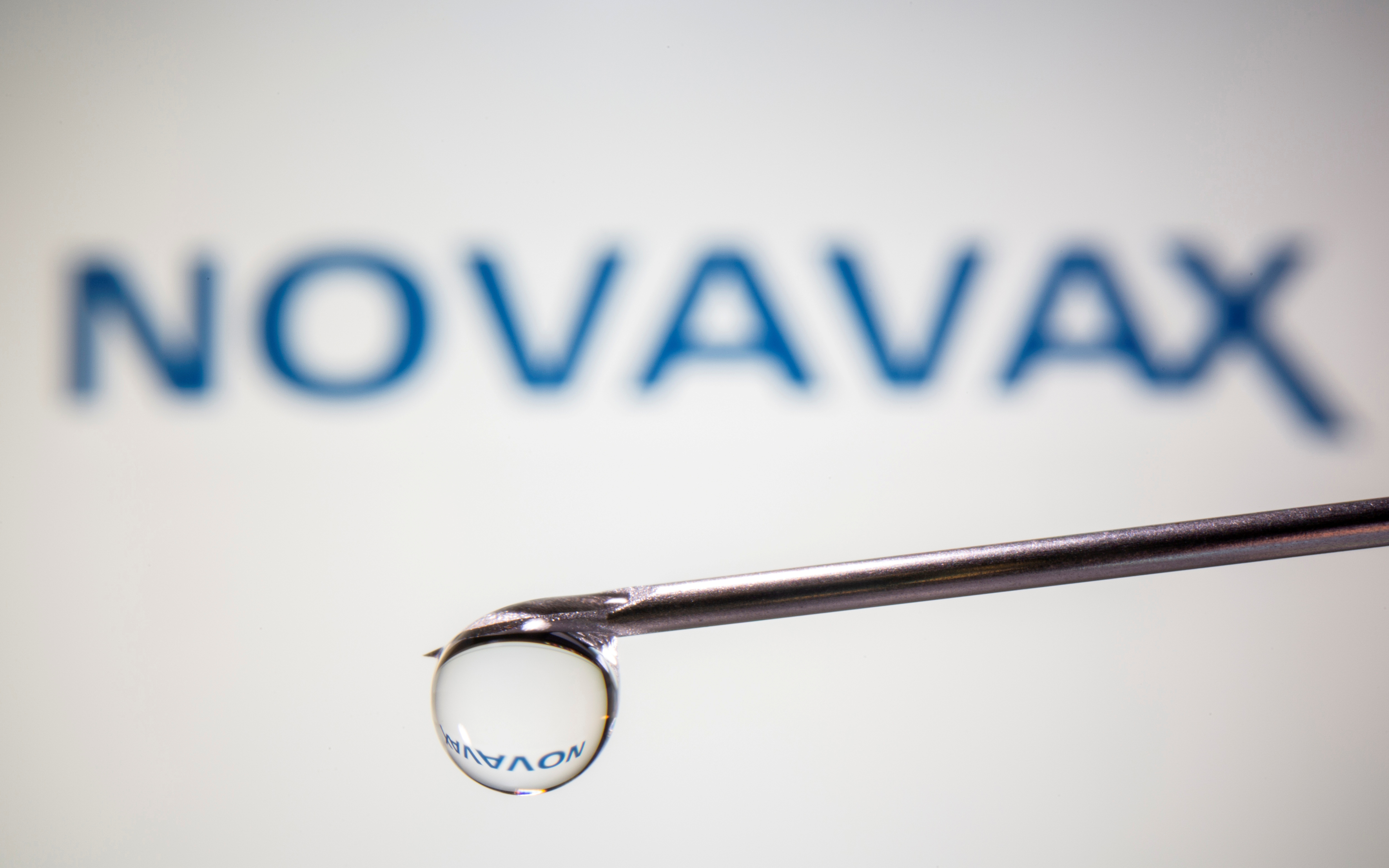 FILE PHOTO: A Novavax logo is reflected in a drop on a syringe needle in this illustration taken November 9, 2020. REUTERS/Dado Ruvic/Illustration/File Photo