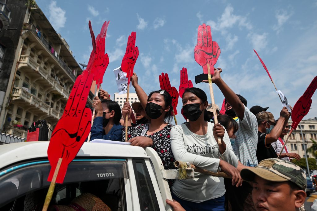 People hold signs depicting a three-finger salute during a rally to protest against the military coup and to demand the release of elected leader Aung San Suu Kyi, in Yangon, Myanmar, February 8, 2021. REUTERS/Stringer