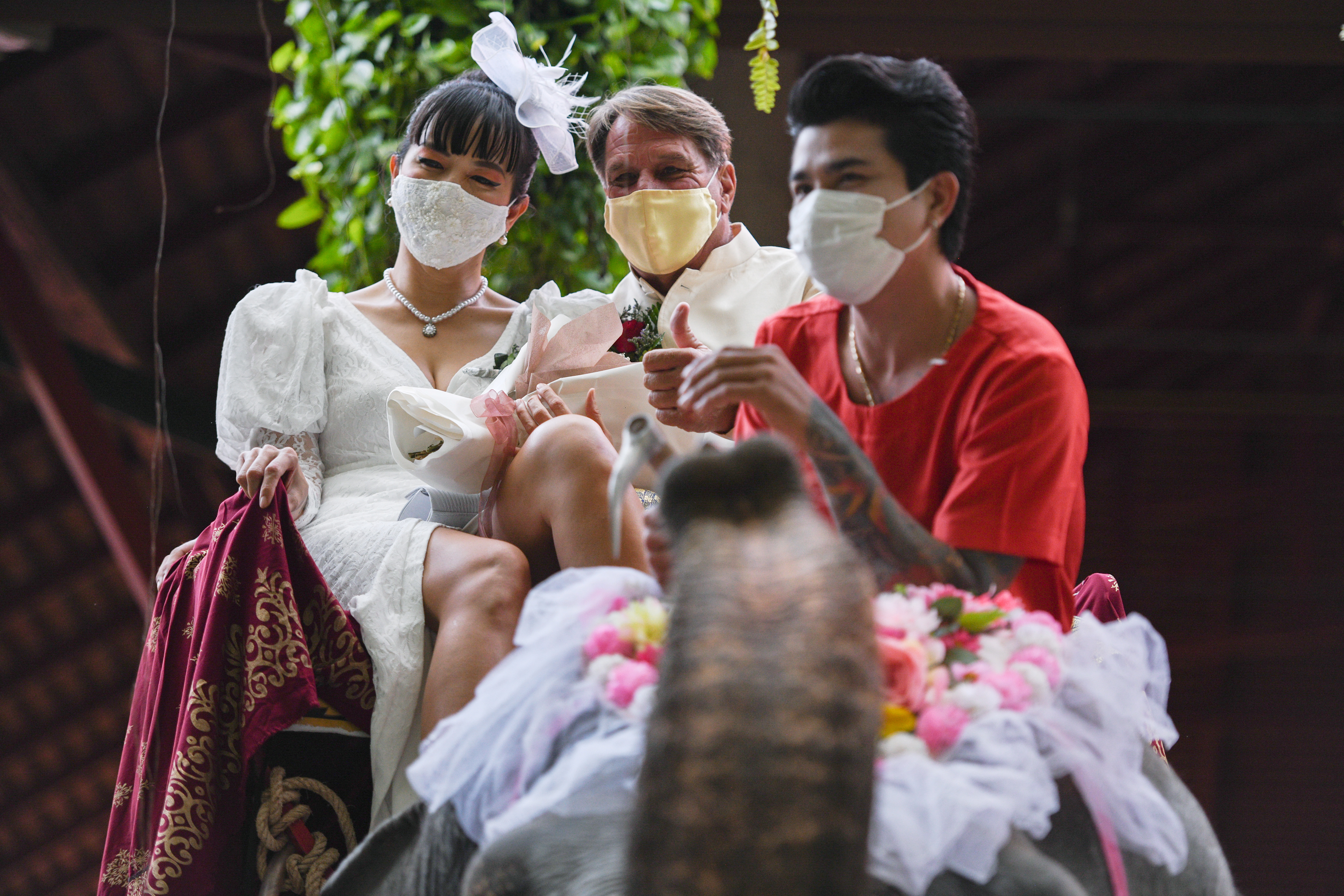 A couple rides an elephant during a Valentine's Day celebration at the Nong Nooch Tropical Garden in Chonburi province, Thailand, February 14, 2021. REUTERS/Chalinee Thirasupa