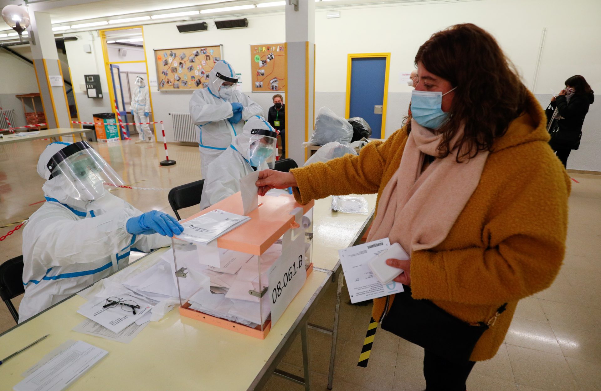 A woman casts her ballot at a polling station during regional election in Catalonia, amid the outbreak of the coronavirus disease (COVID-19), in Barcelona, Spain, February 14, 2021. REUTERS/Albert Gea