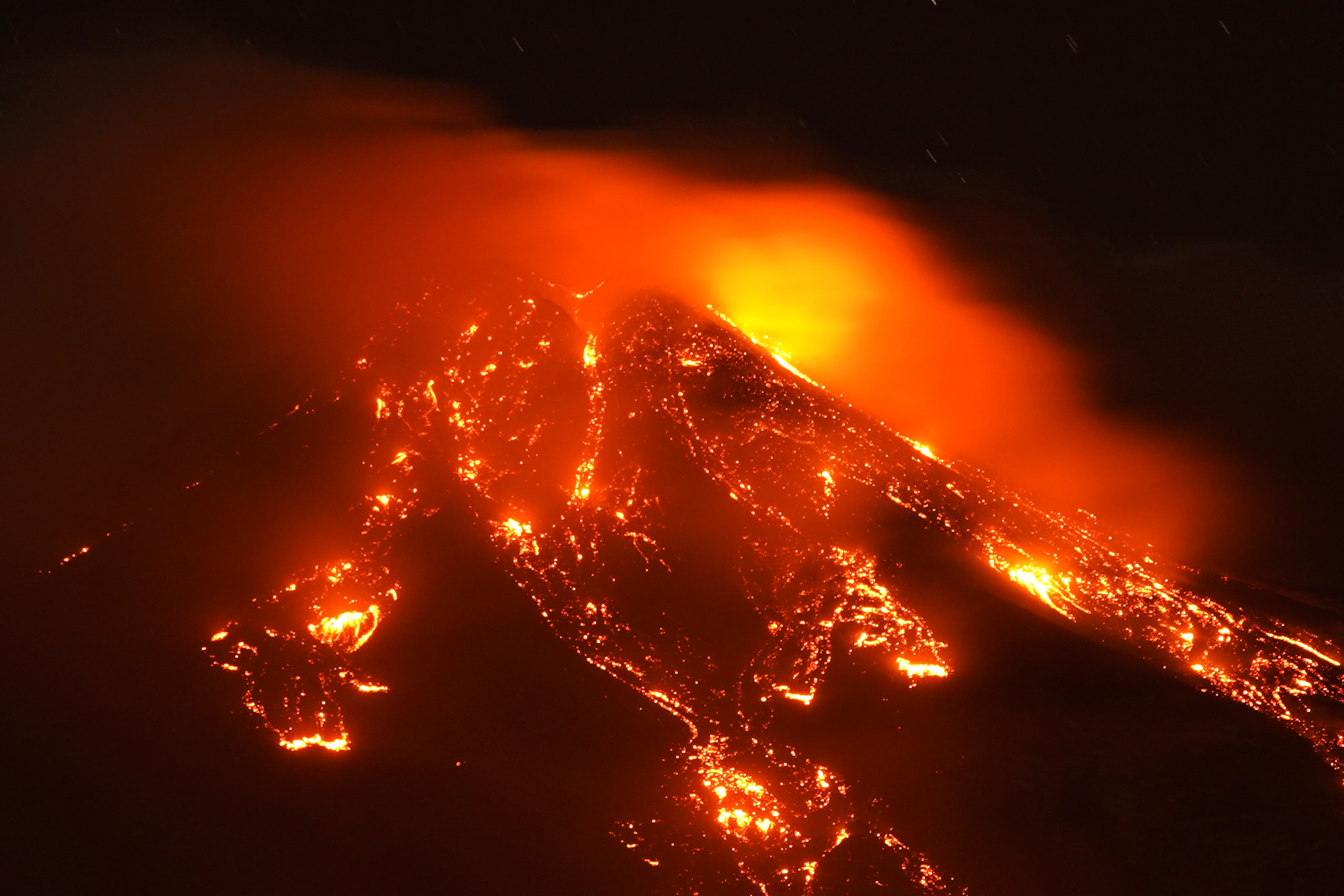 Streams of red hot lava flow as Mount Etna, Europe's most active volcano, leaps into action, seen from Giarre, Italy, February 16, 2021. REUTERS/Antonio Parrinello
