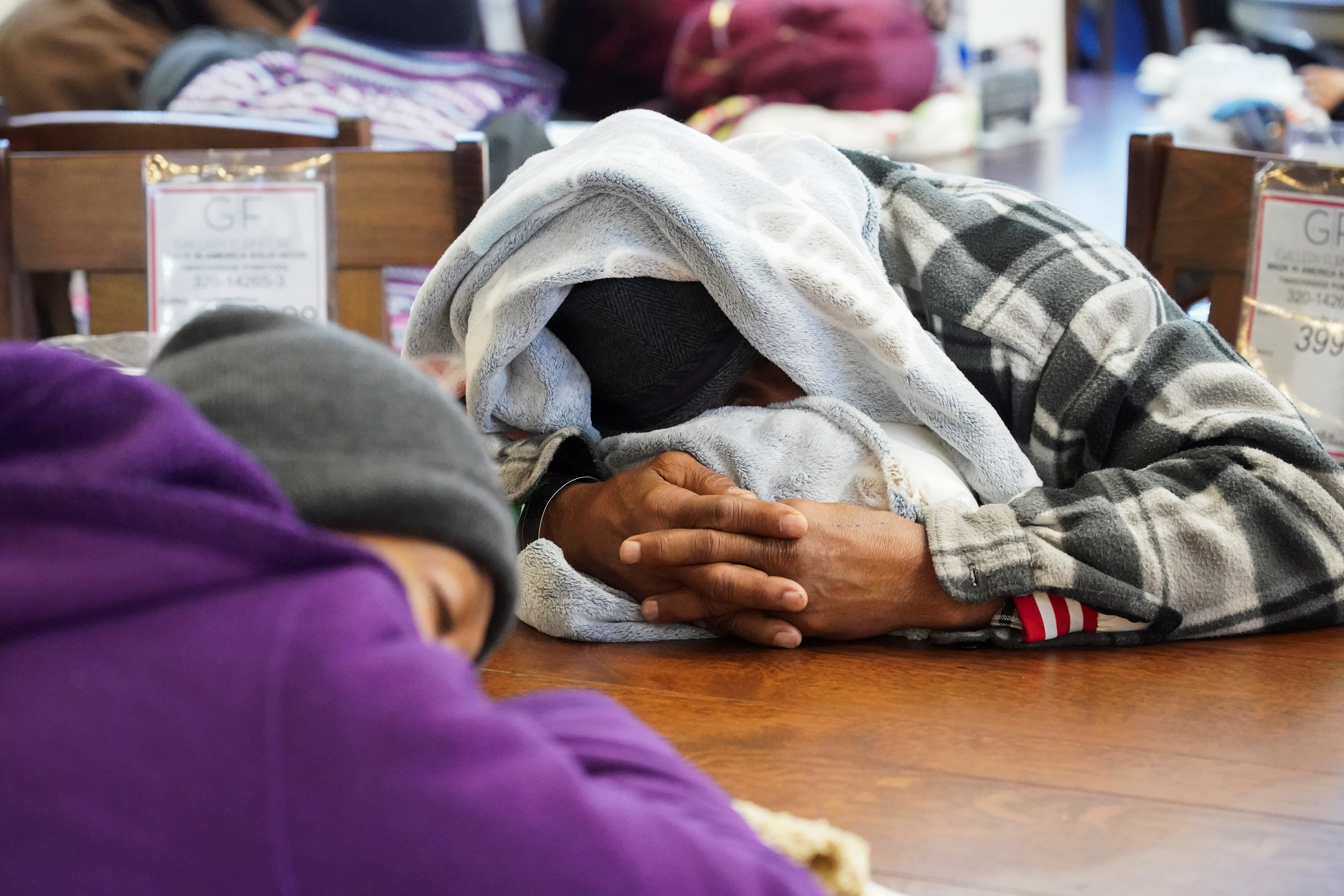 People take shelter at Gallery Furniture store which opened its door and transformed into a warming station after winter weather caused electricity blackouts in Houston, Texas, U.S. February 17, 2021.  REUTERS/Go Nakamura