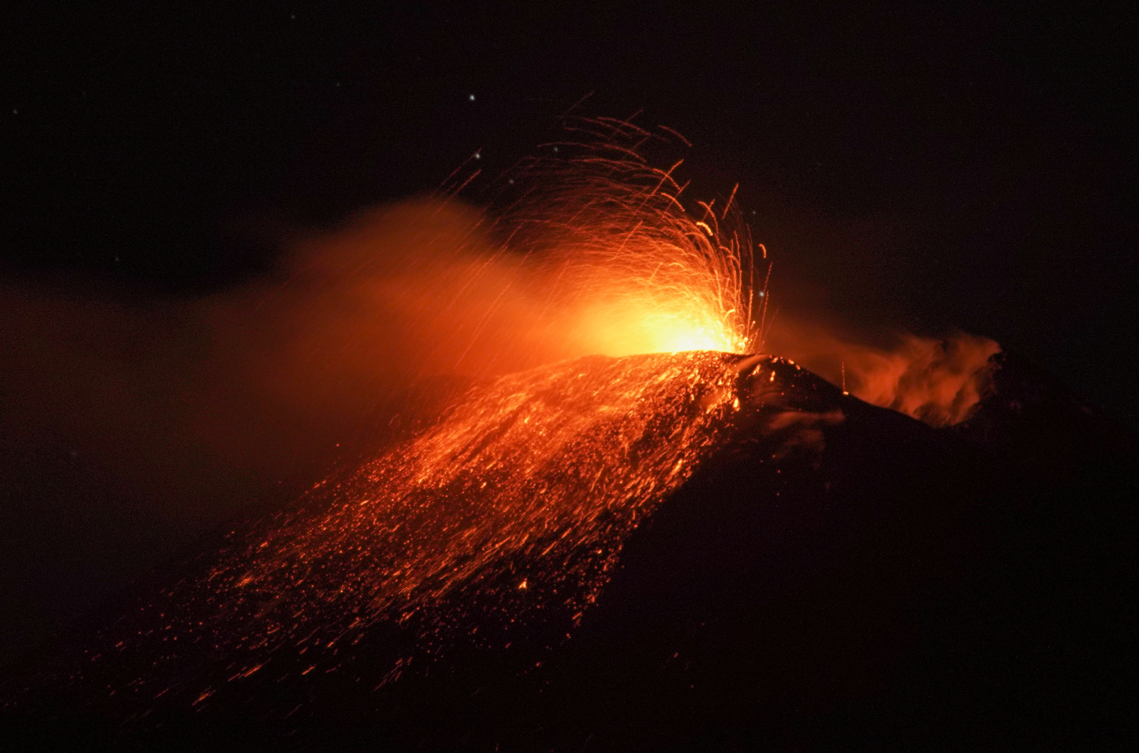 An eruption from Mount Etna lights up the sky during the night, seen from the small village of Fornazzo under the volcano, Italy, January 13, 2021. Picture taken January 13, 2021. REUTERS/Antonio Parrinello