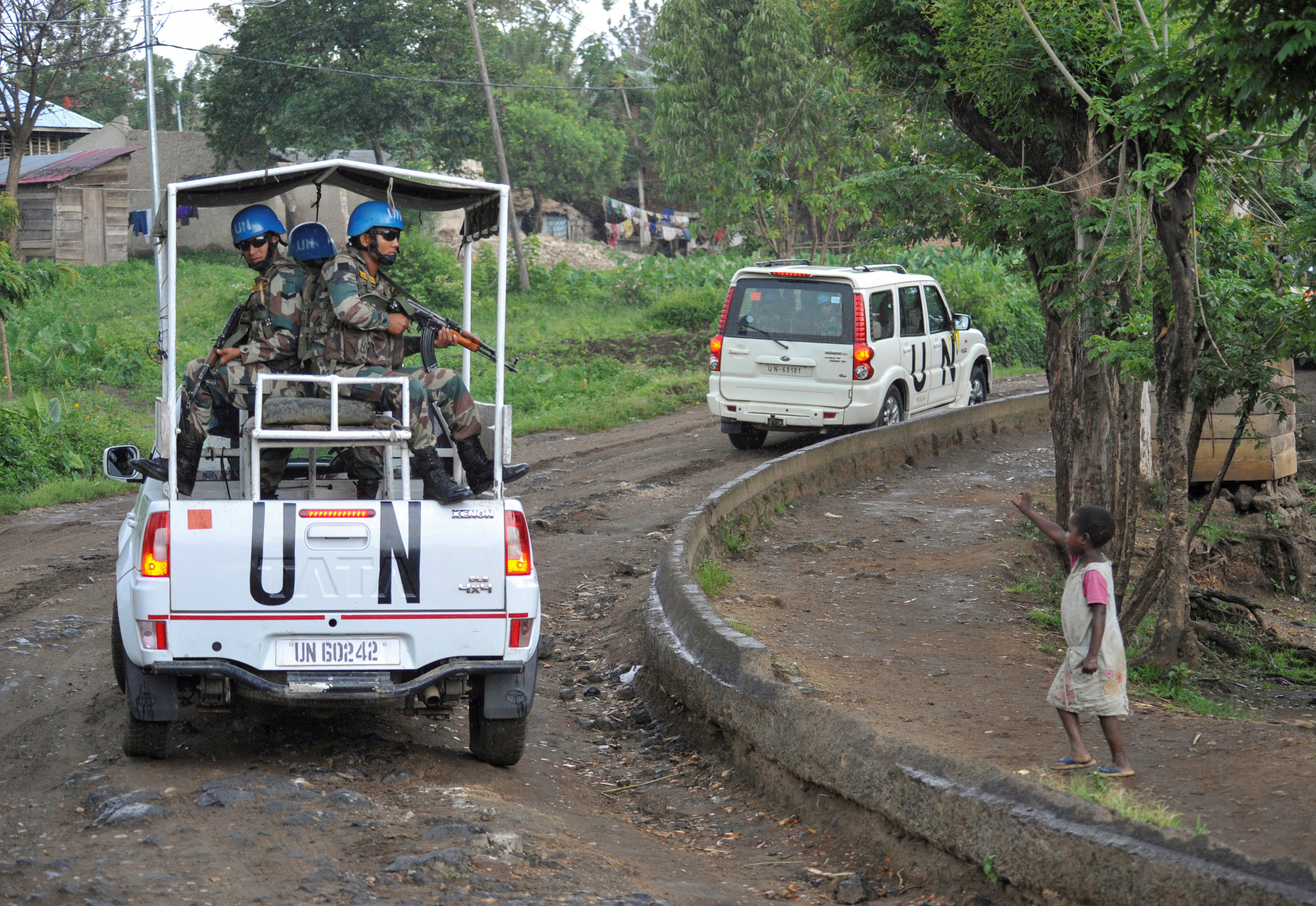 FILE PHOTO: A Congolese girl gestures to peacekeepers from India as they ride on patrol in the town of Kiwanja