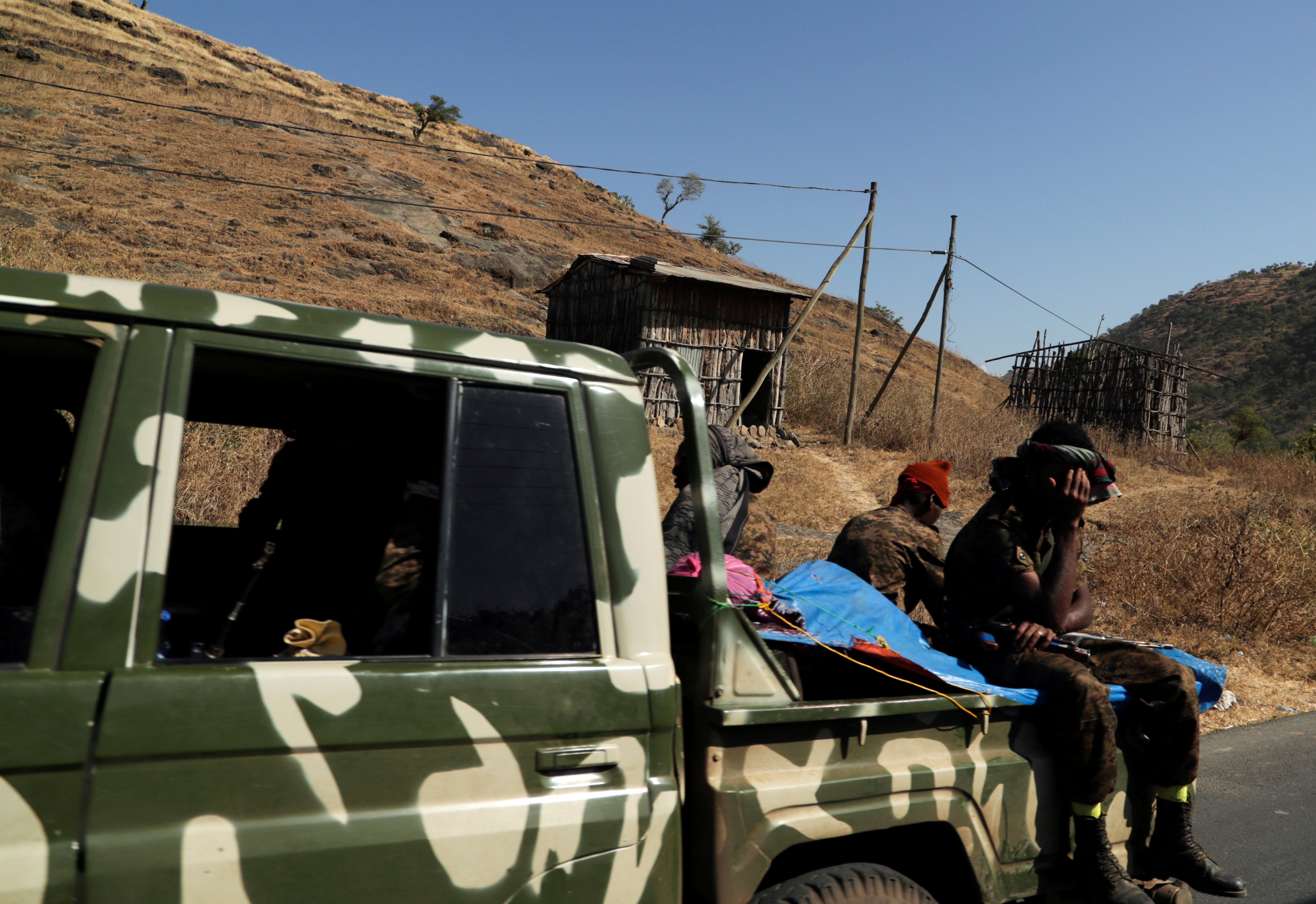 FILE PHOTO: Members of the Ethiopian National Defense Force (ENDF) ride on their pickup truck as they head to mission in Sanja, Amhara region, near a border with Tigray, Ethiopia November 9, 2020. REUTERS/Tiksa Negeri/File Photo