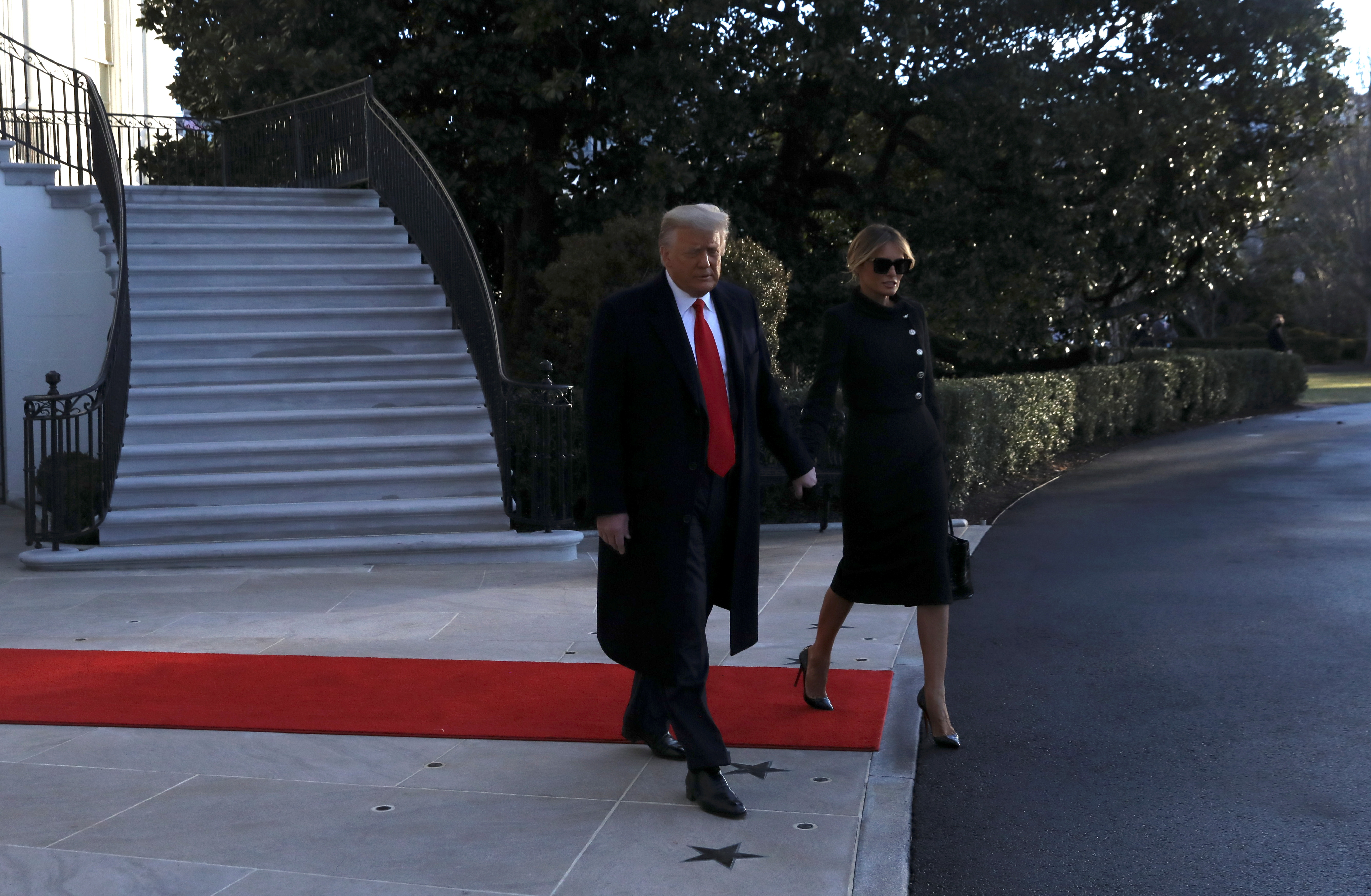 U.S. President Donald Trump and first lady Melania Trump leave the White House to board Marine One ahead of the inauguration of president-elect Joe Biden, in Washington, U.S., January 20, 2021. REUTERS/Leah Millis