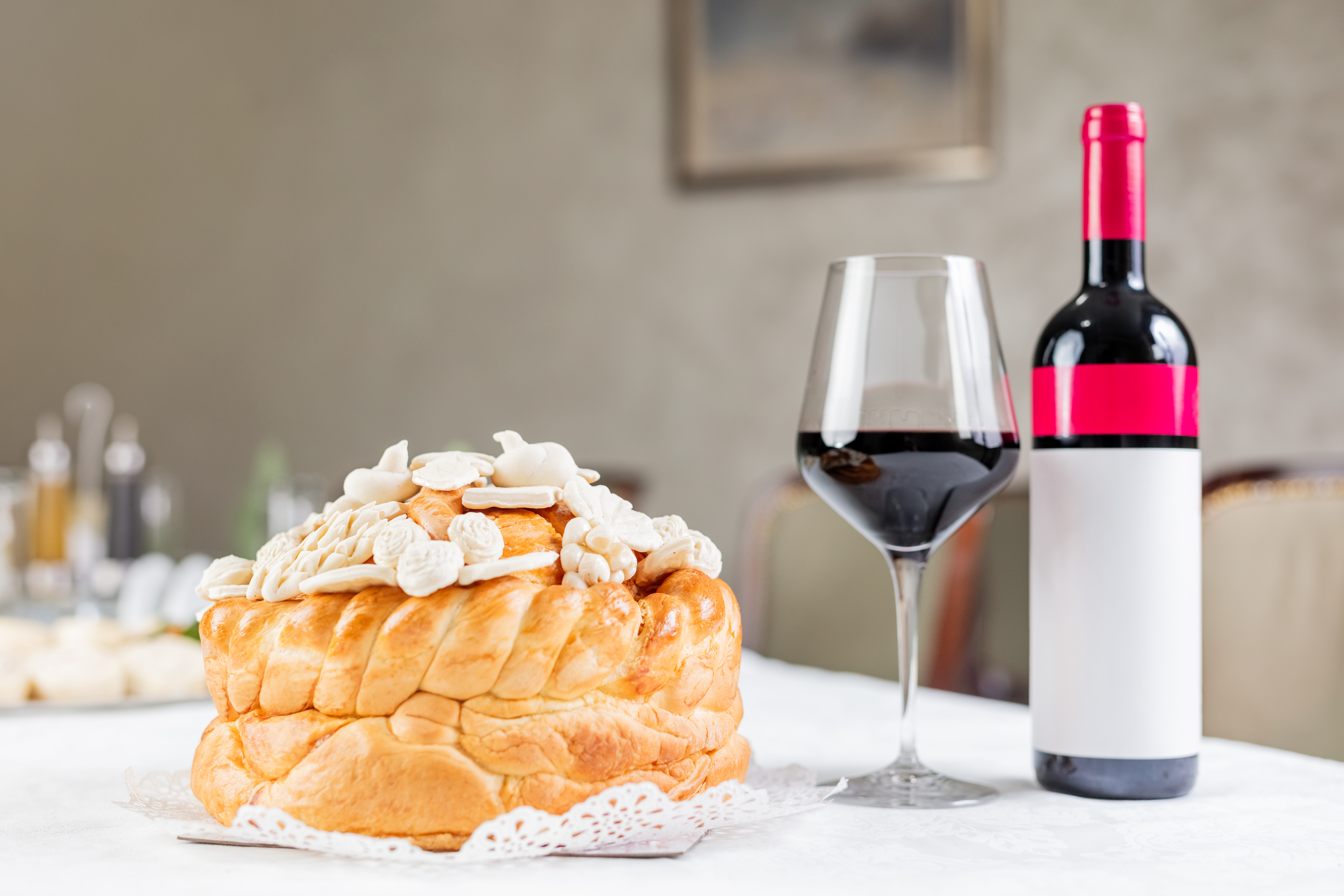 8.12. (a) Slavska pogaca stock-photo-bottle-and-glass-of-wine-and-orthodox-church-bread-with-decoration-on-table-at-restaurant-or-home-1638250897