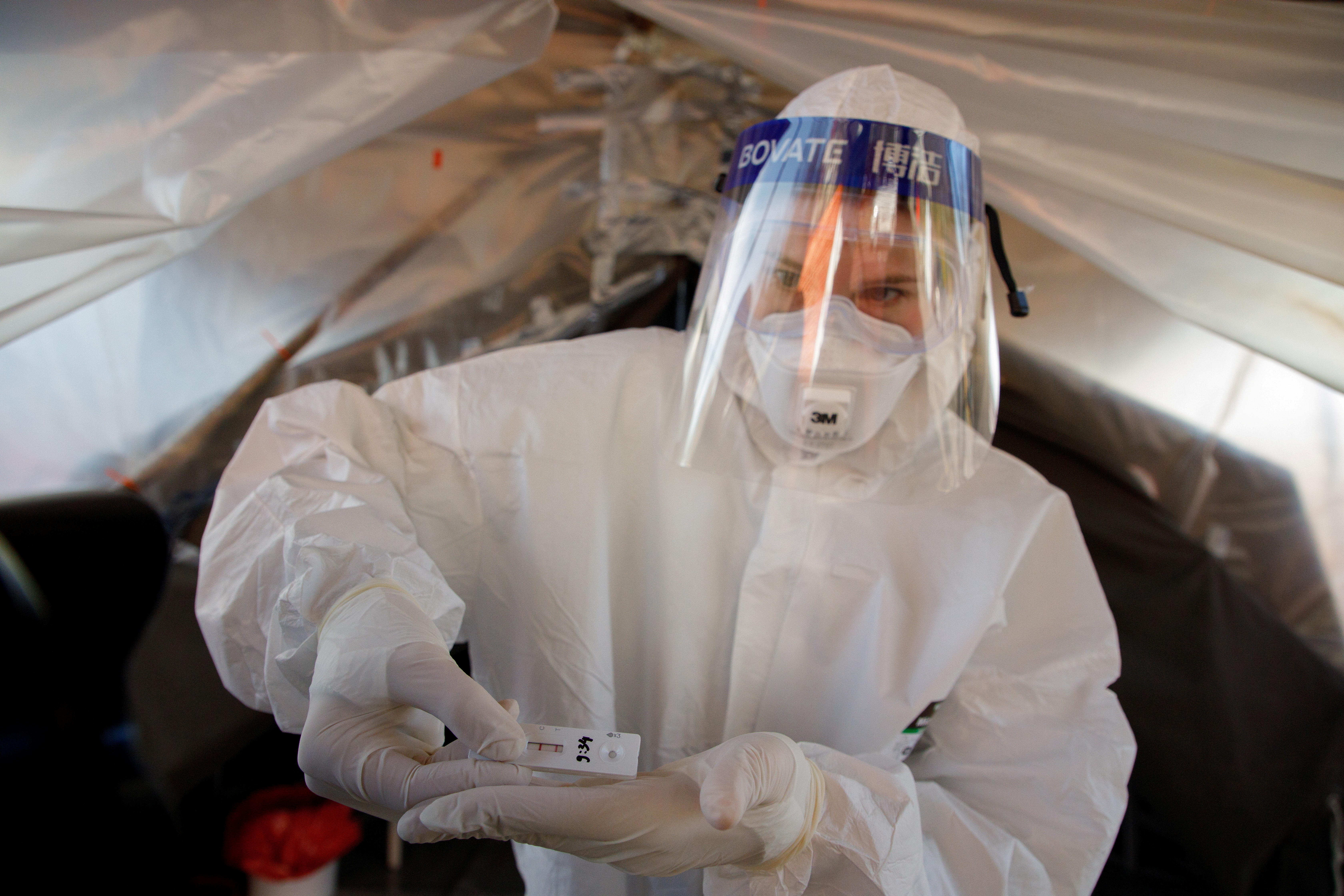 Medical worker shows a positive novel coronavirus antigen test as they prepare to check 60,000 people in Zagreb during the pandemic, in Croatia, November 23, 2020. REUTERS/Antonio Bronic