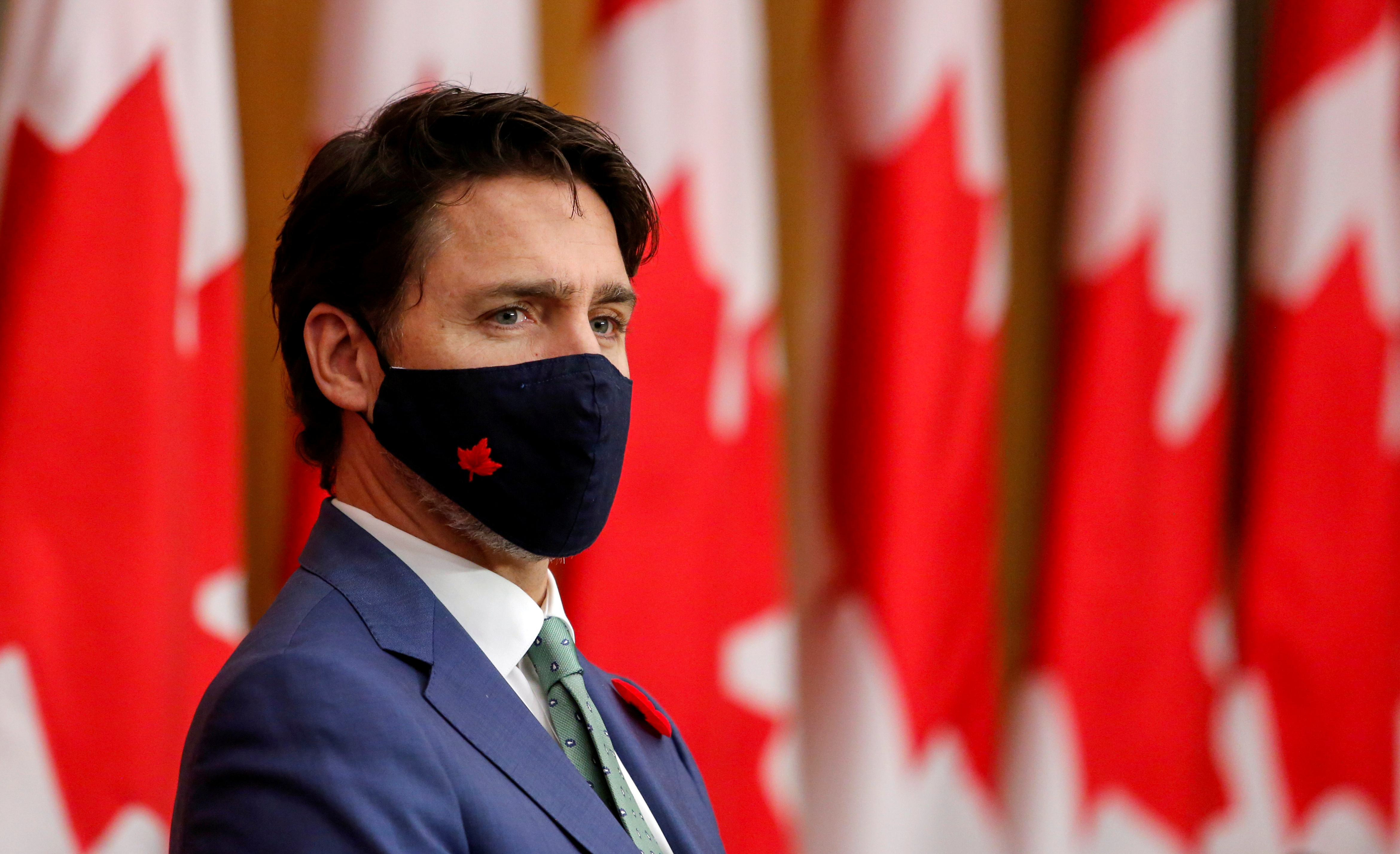 FILE PHOTO: Canadian Prime Minister Justin Trudeau listens while wearing a mask at a news conference held to discuss the country's coronavirus disease (COVID-19) response in Ottawa, Ontario, Canada November 6, 2020. REUTERS/Patrick Doyle/File Photo