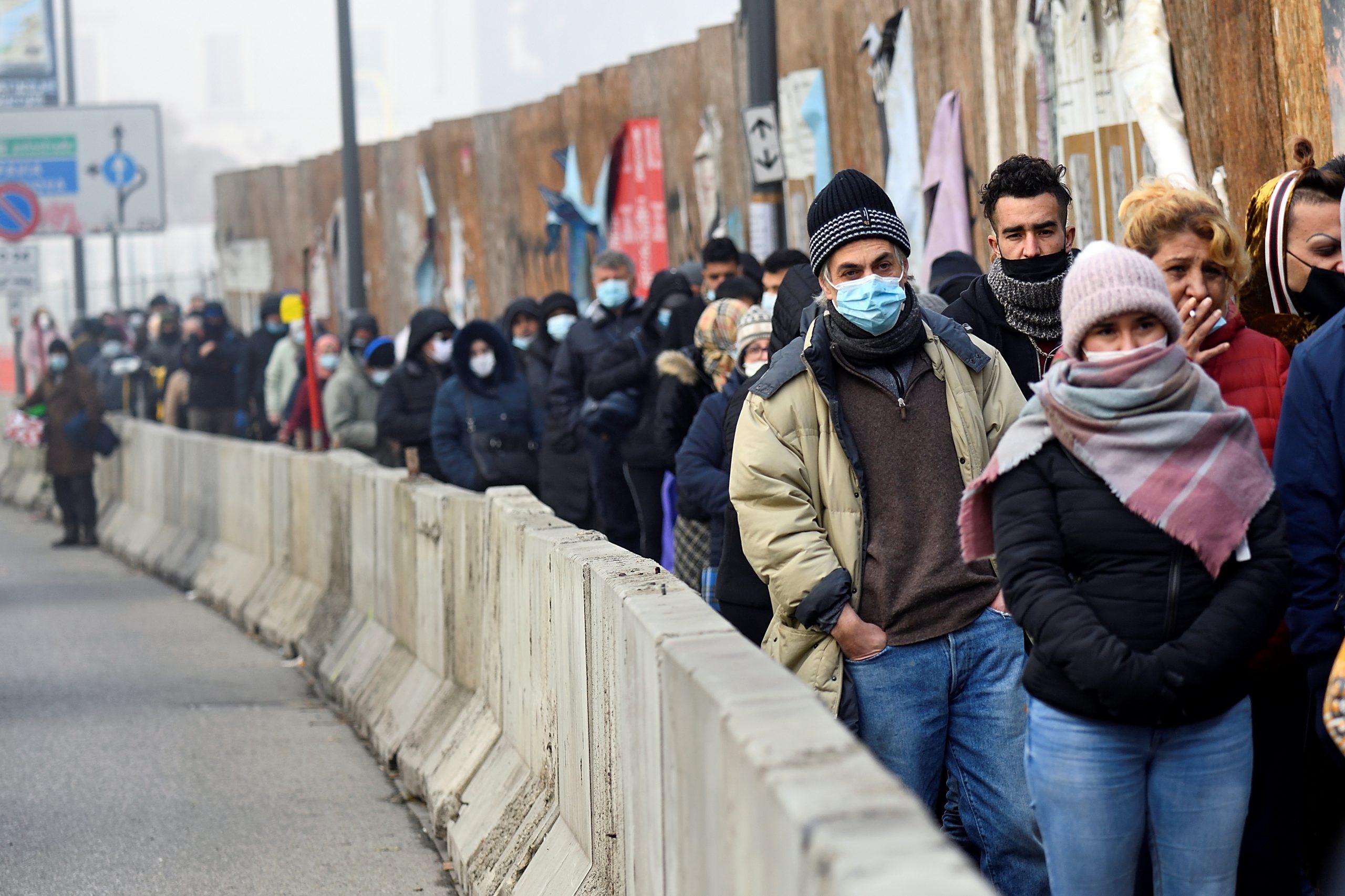 People queue for free food as Italians struggle to cope in a tough economic climate amid the coronavirus disease (COVID-19) pandemic in Milan, Italy December 14, 2020. REUTERS/Flavio Lo Scalzo