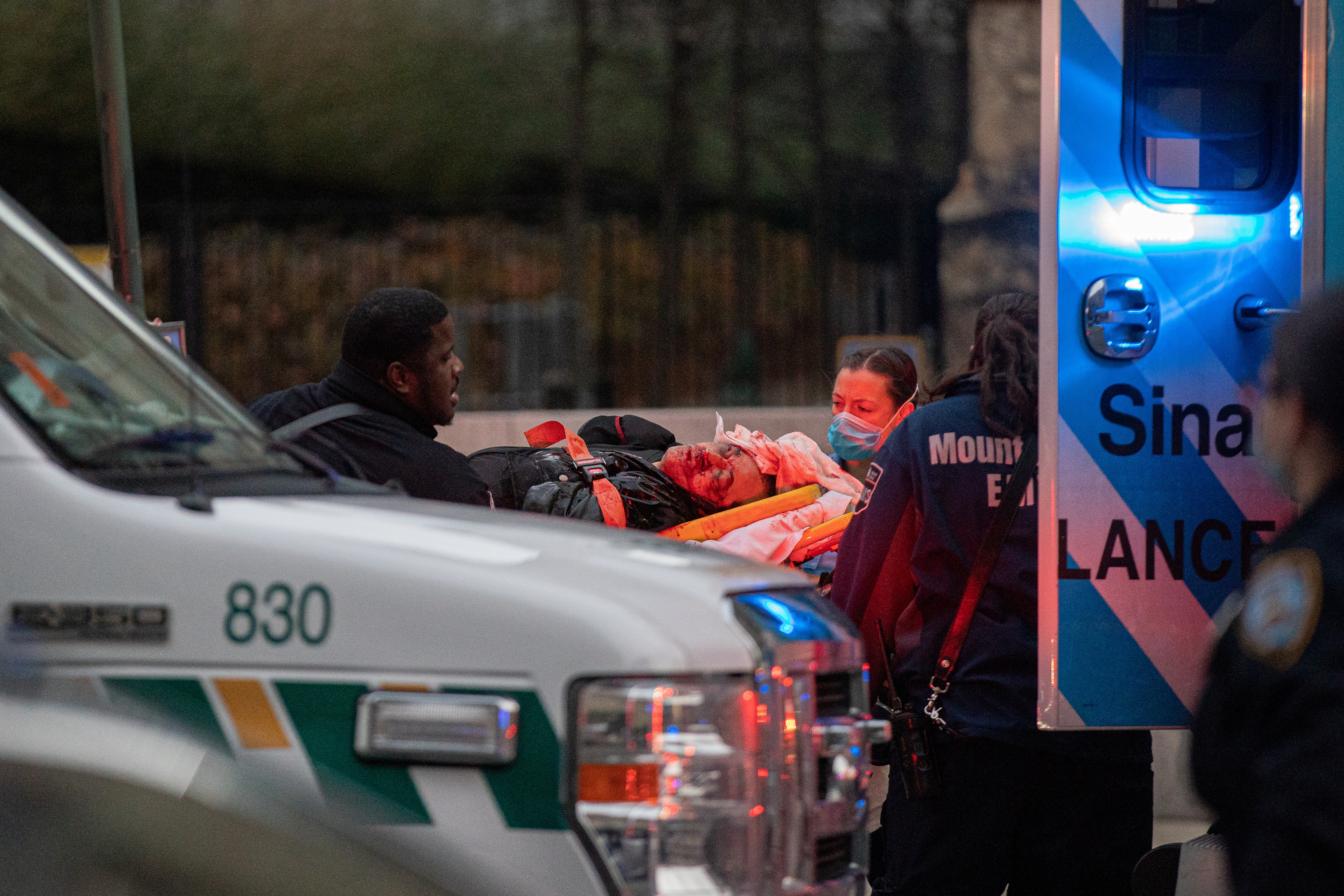 A suspect is taken to an ambulance after he was shot outside the Cathedral Church of St. John the Divine in the Manhattan borough of New York City