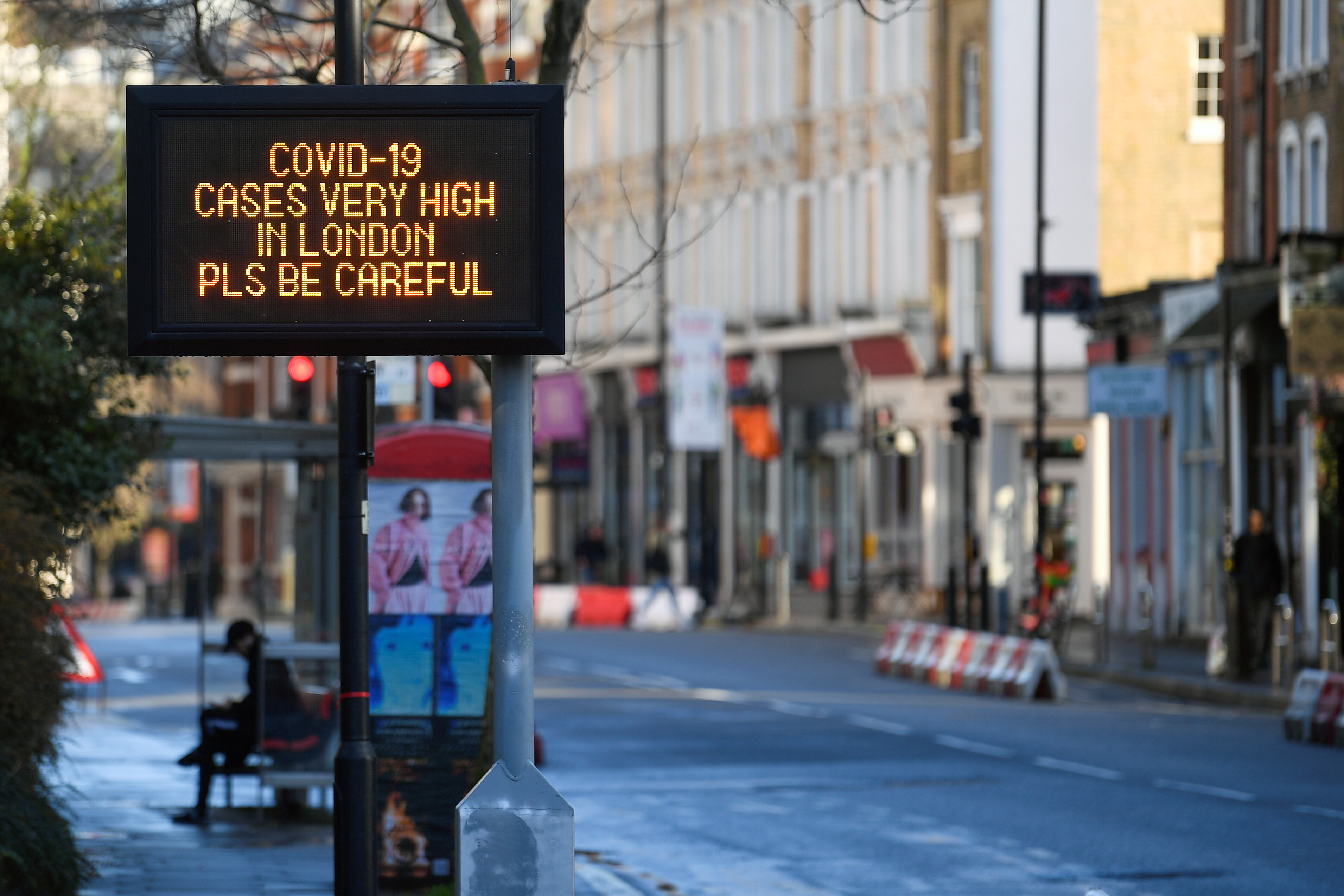 A public health information message is displayed amid the spread of the coronavirus disease (COVID-19) as new restrictions come into force, in London, Britain, December 20, 2020. REUTERS/Toby Melville