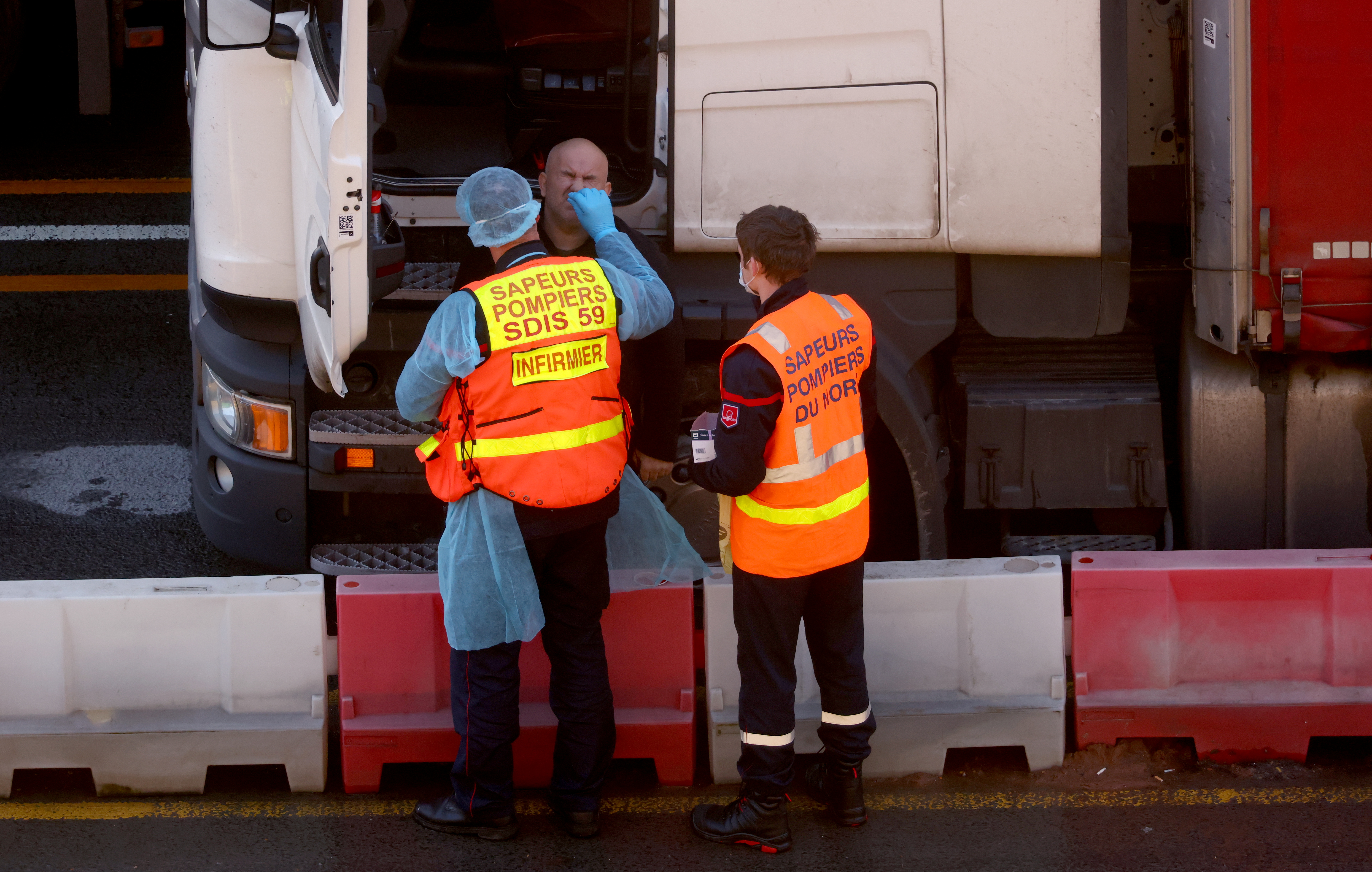 French officials test a driver at the Port of Dover, amid the coronavirus disease (COVID-19) outbreak, in Dover, Britain, December 24, 2020. REUTERS/Simon Dawson