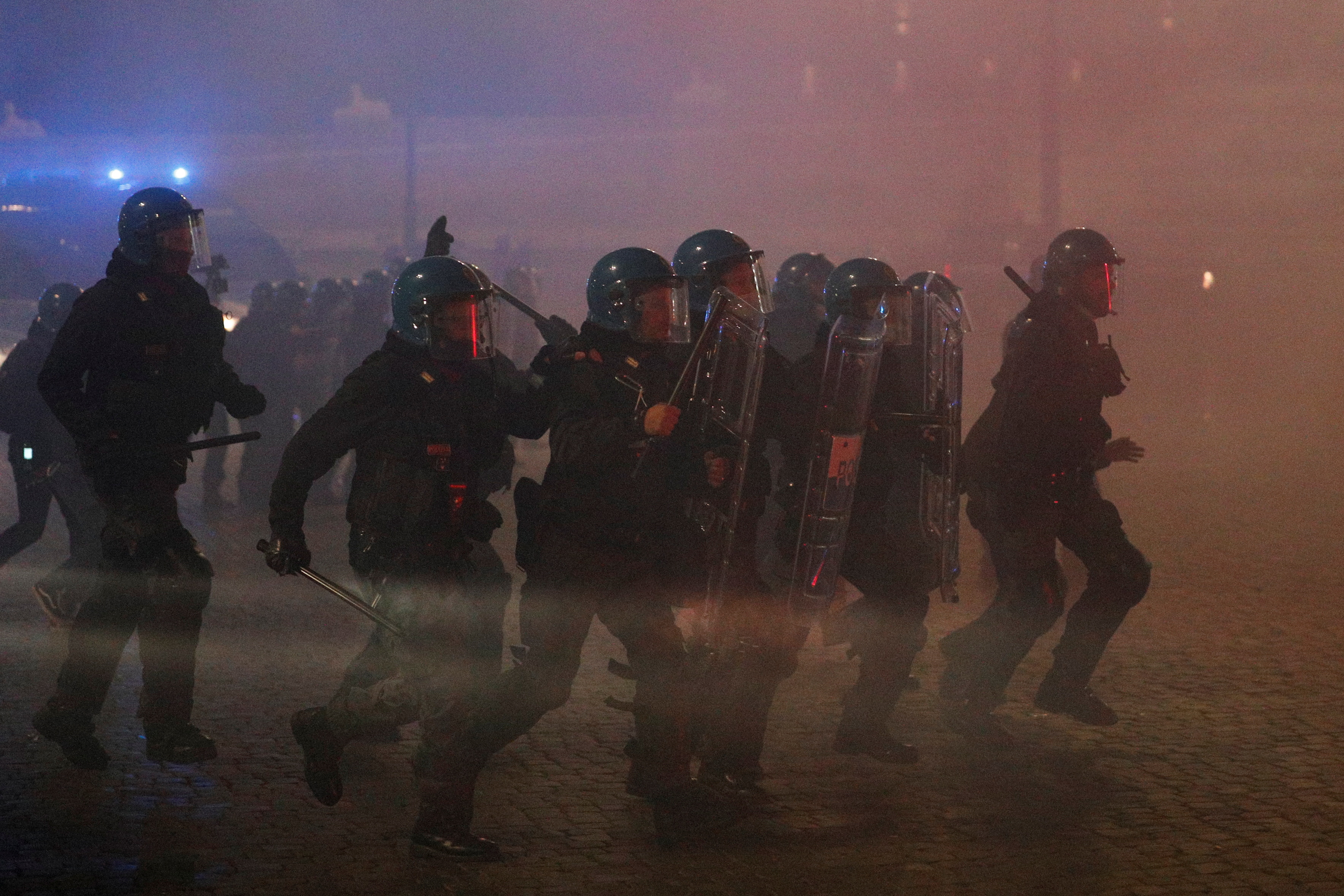 Police officers take position as they clash with far right demonstrators during a protest over the restrictions put in place to curb the coronavirus disease (COVID-19) infections in Rome, Italy October 27, 2020. REUTERS/Guglielmo Mangiapane