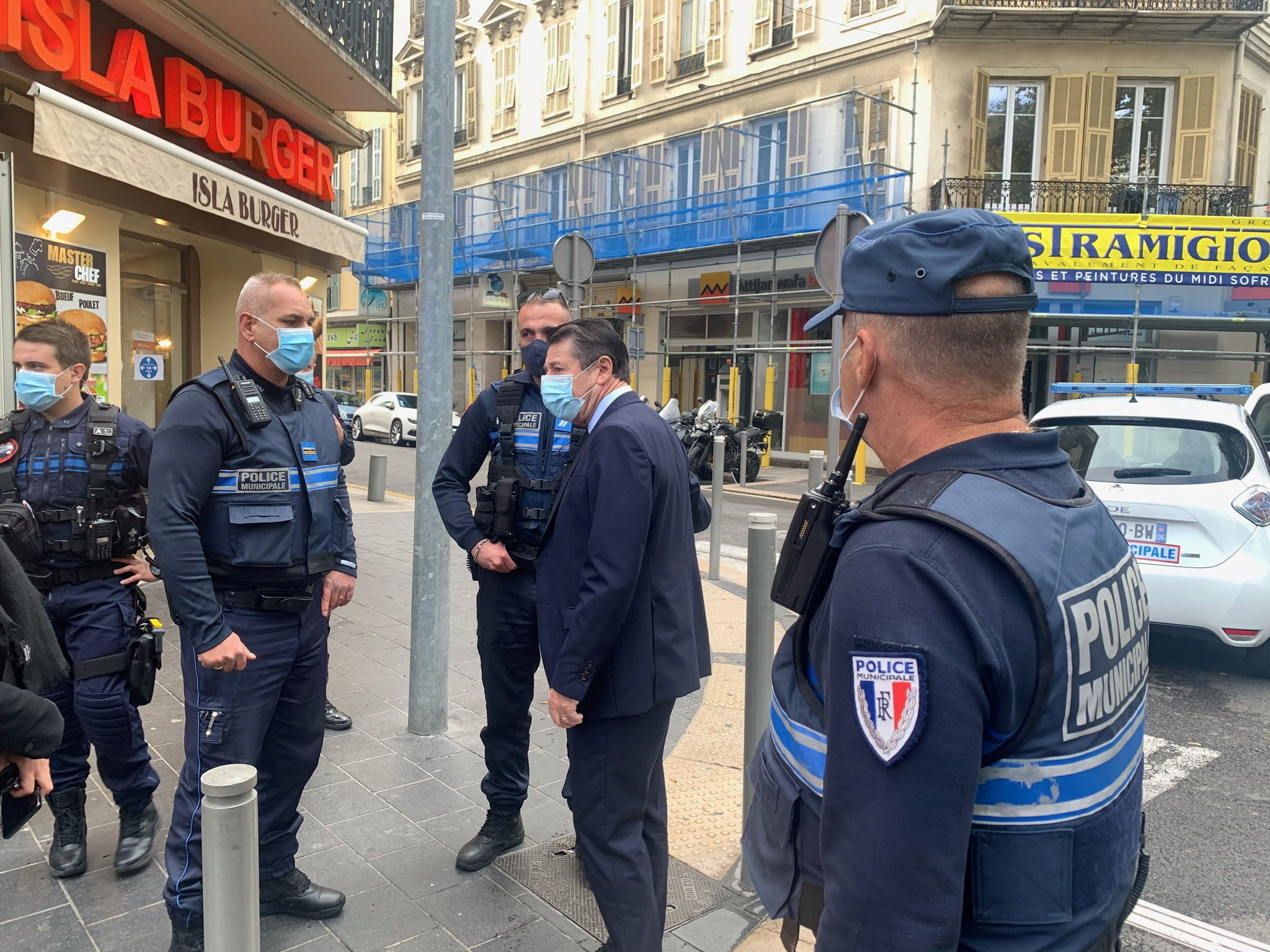Nice Mayor Christian Estrosi talks to Municipal Police at the site of a knife attack in church in Nice