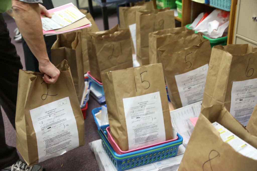 Election officials process ballots at a central count facility handling absentee ballots on Election Day in Kenosha, Wisconsin, U.S. November 3, 2020.  REUTERS/Daniel Acker