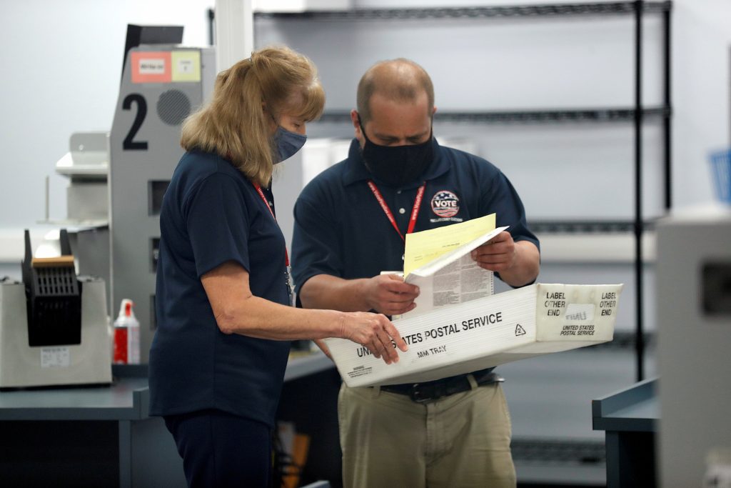 Members of the Pinellas County canvassing board process ballots on Election Day in Largo, Florida U.S. November 3, 2020.  REUTERS/Octavio Jones