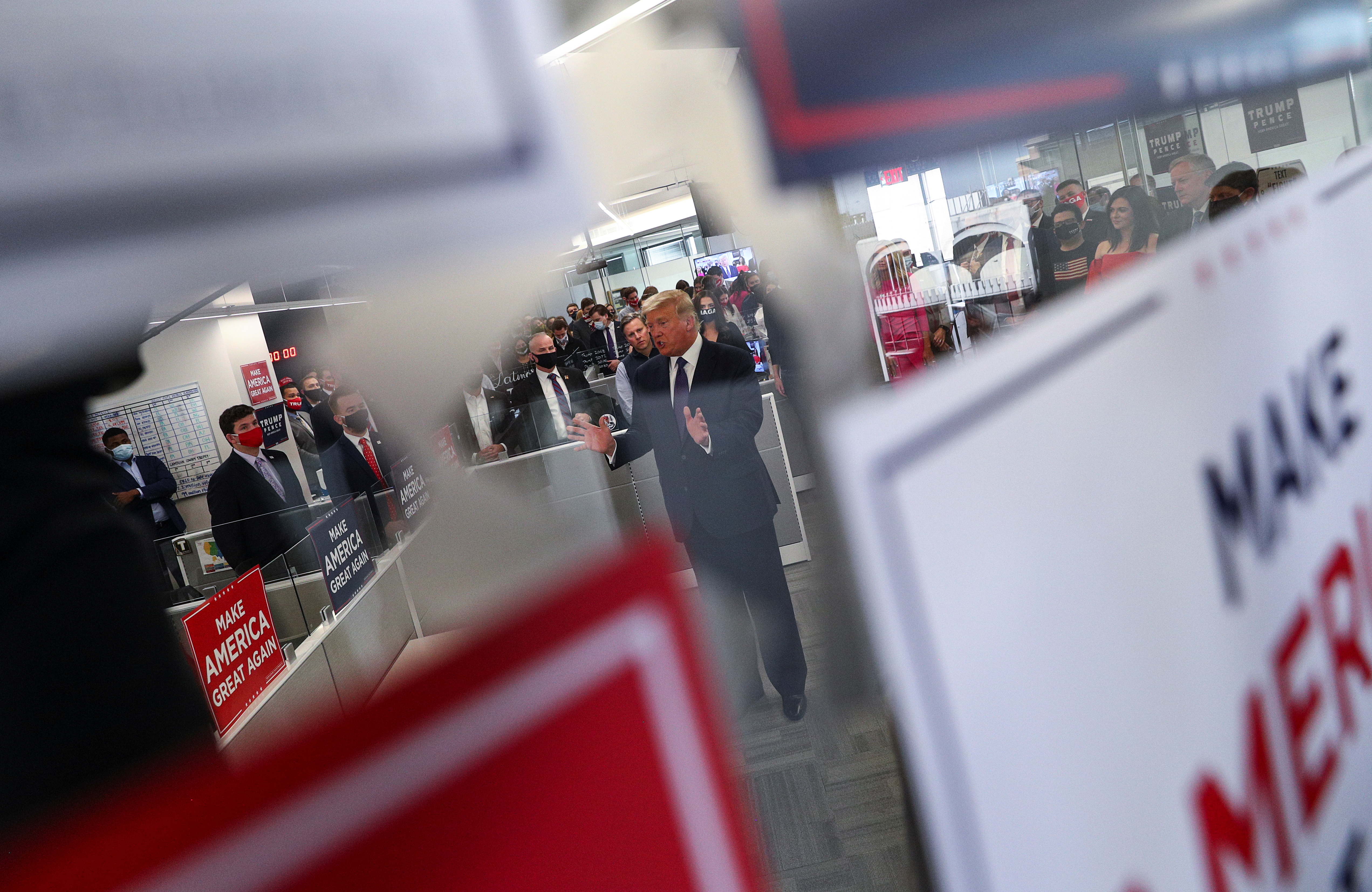 U.S. President Donald Trump greets staff members as he visits his presidential campaign headquarters on Election Day in nearby Arlington, Virginia, U.S., November 3, 2020. REUTERS/Tom Brenner