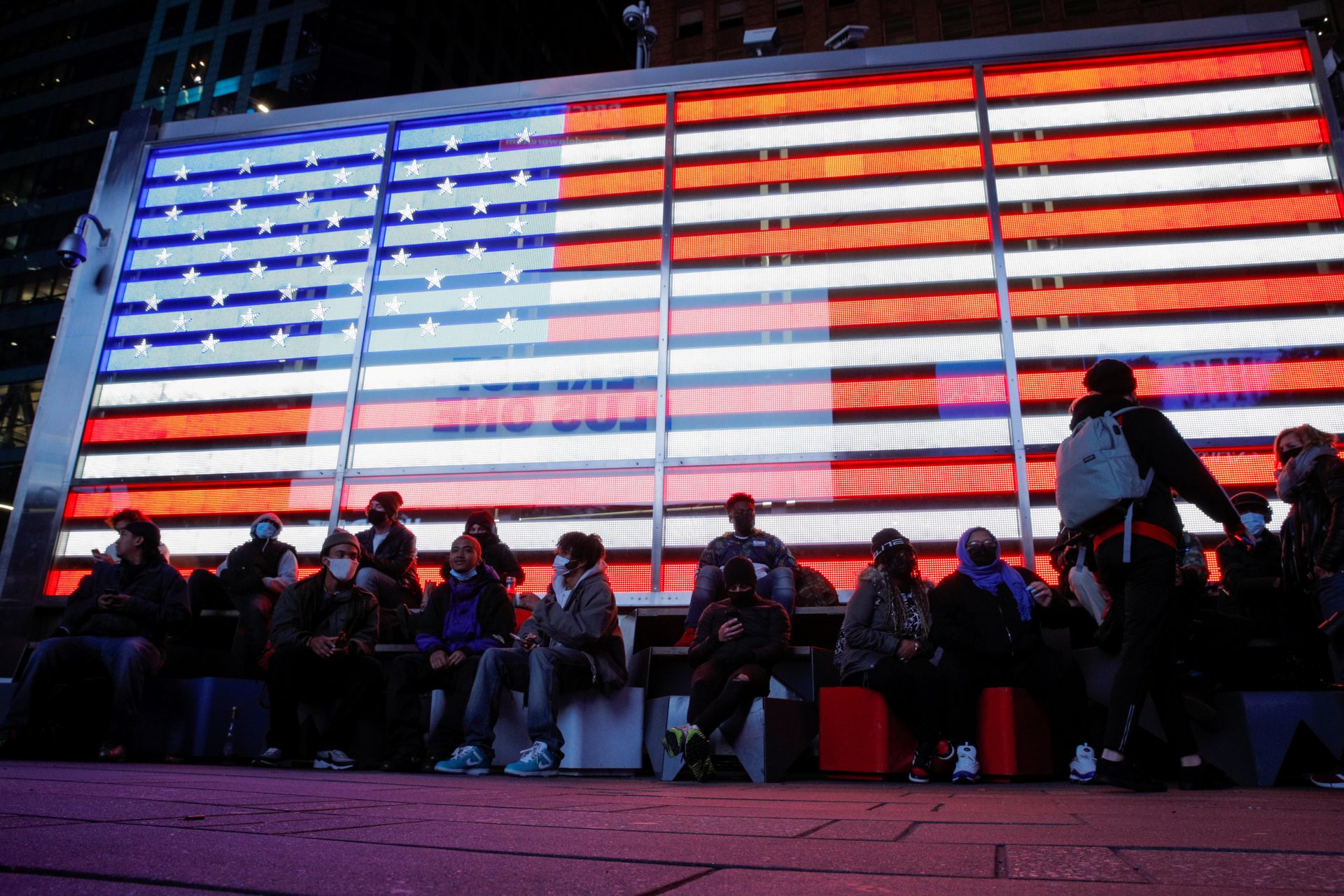People watch early election results in Times Square in New York City, New York, U.S. November 3, 2020. REUTERS/Brendan McDermid