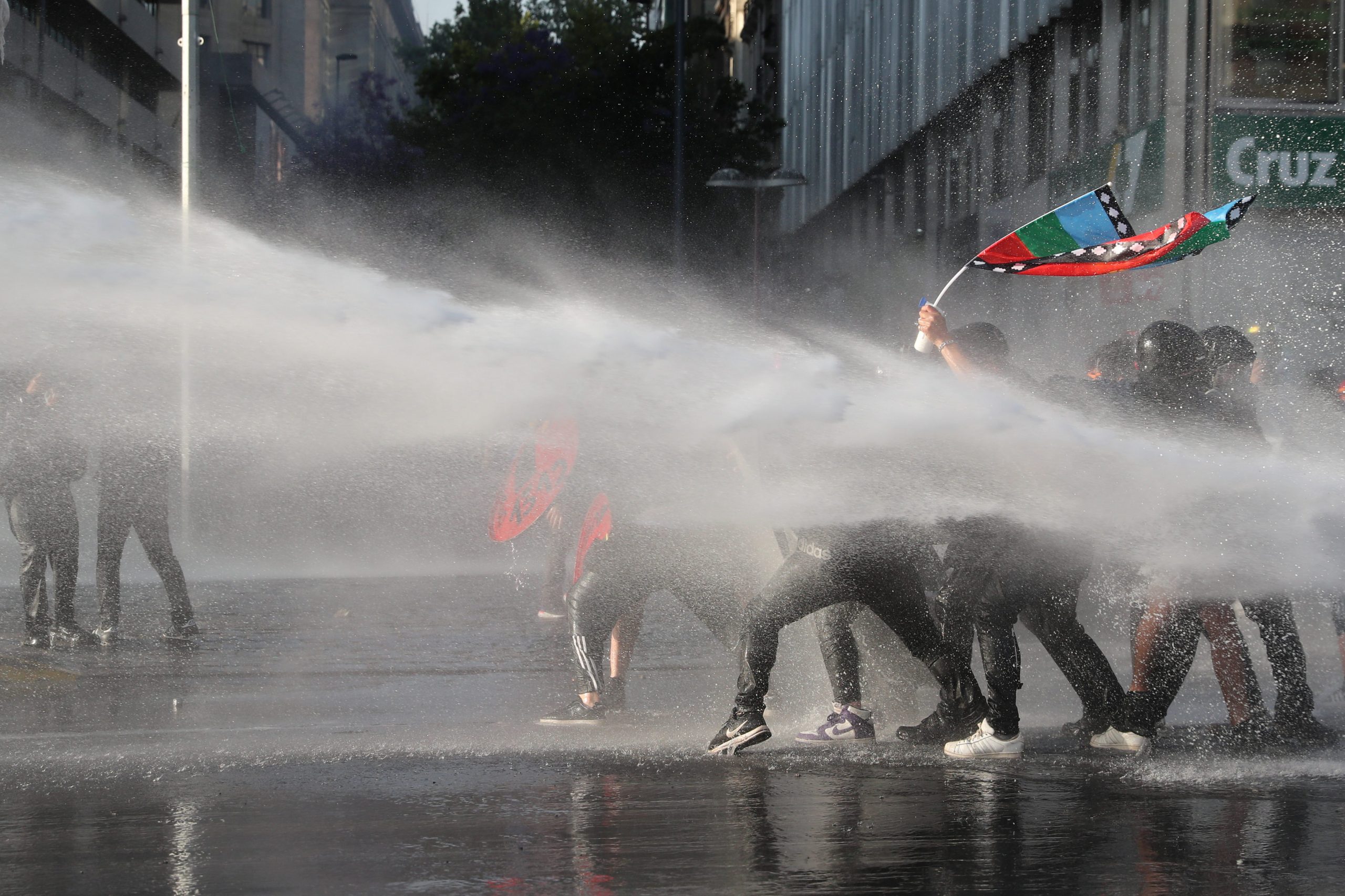 A jet of water is released on demonstrators during a protest against Chile's government in Santiago, Chile November 20, 2020. REUTERS/Ivan Alvarado