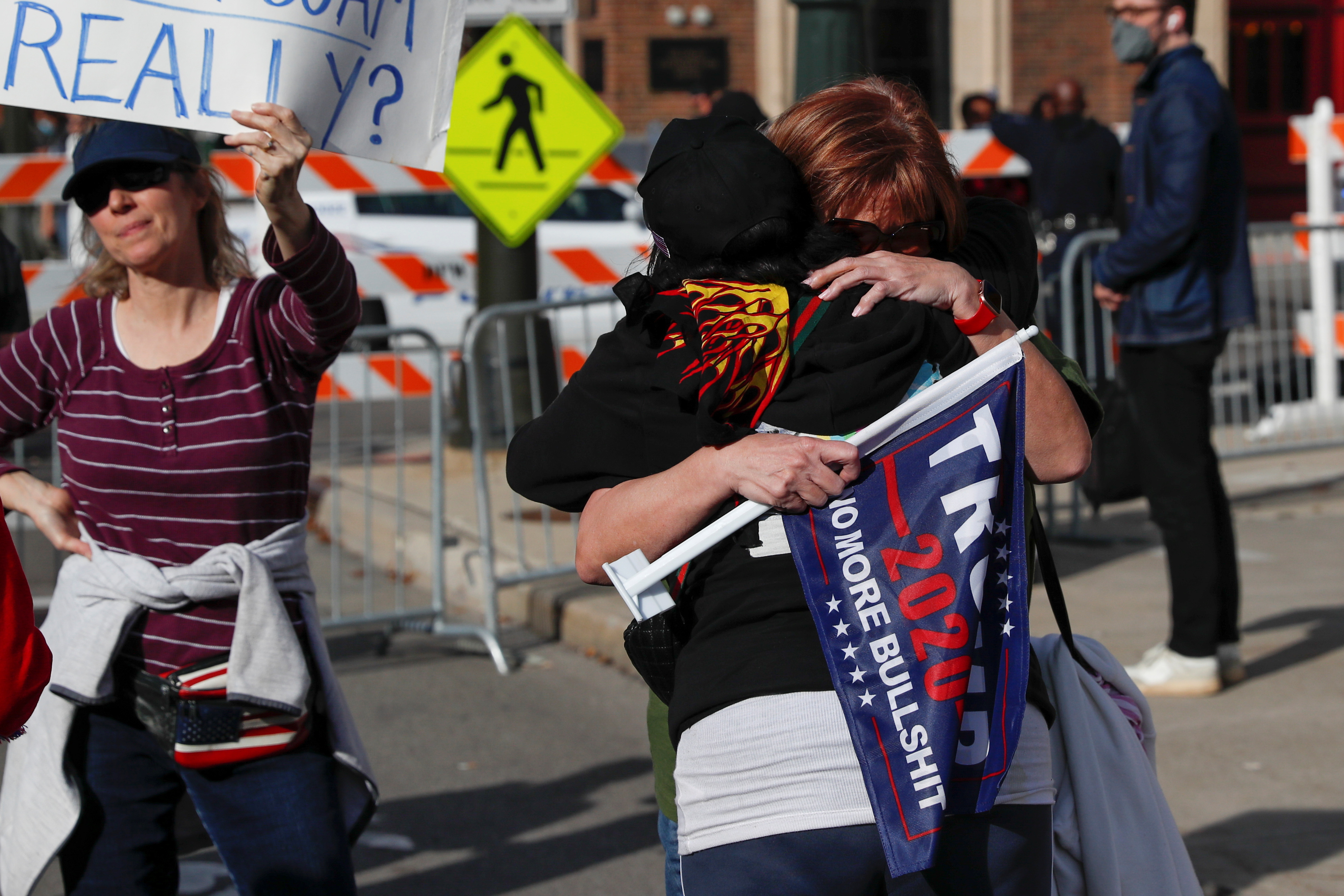 Supporters of U.S. President Donald Trump hug outside the TCF Center as votes continue to be counted following the 2020 U.S. presidential election, in Detroit