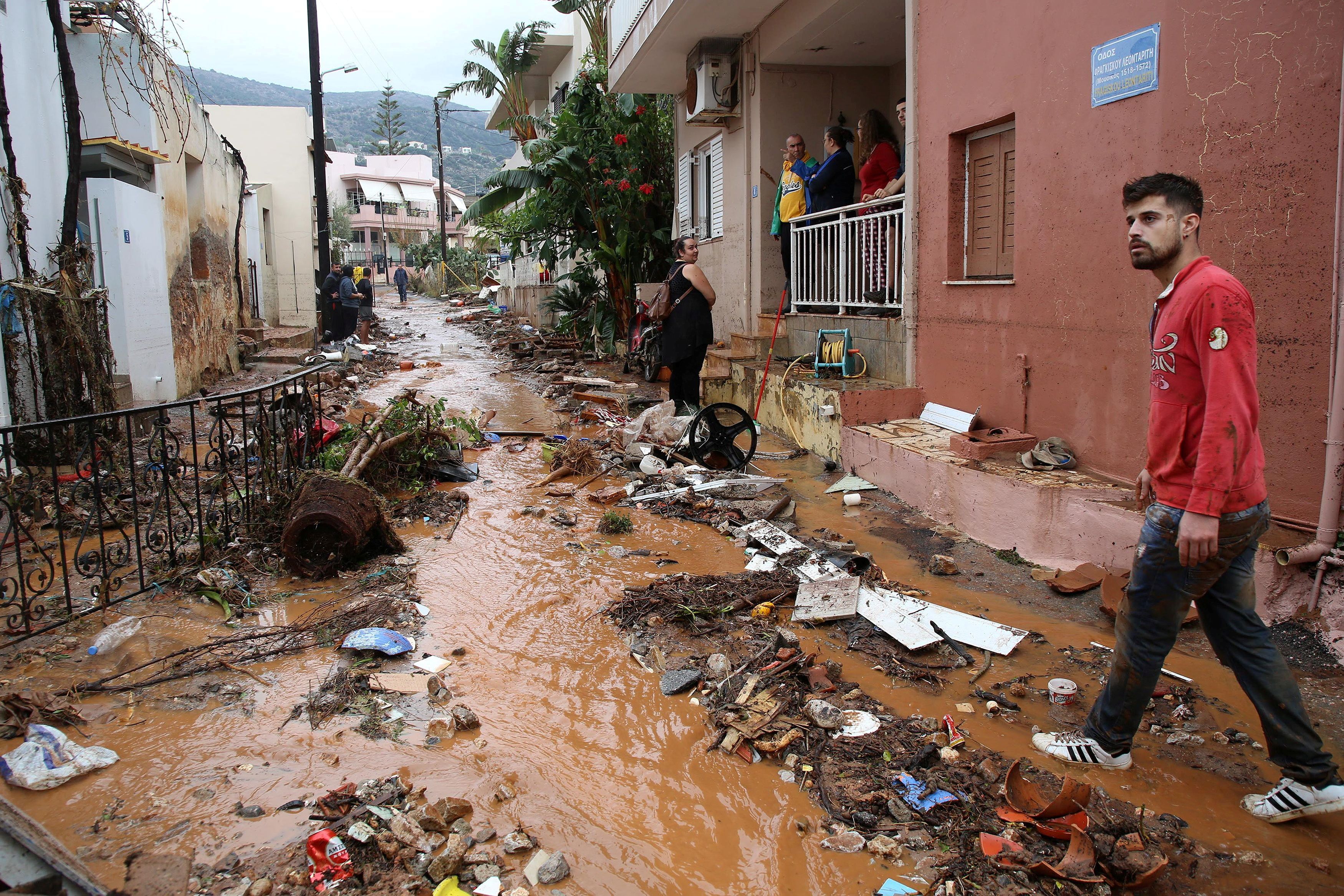 Locals stand among debris following heavy rainfall at the village of Gournes on the island of Crete, Greece, November 10, 2020. REUTERS/Stefanos Rapanis     TPX IMAGES OF THE DAY