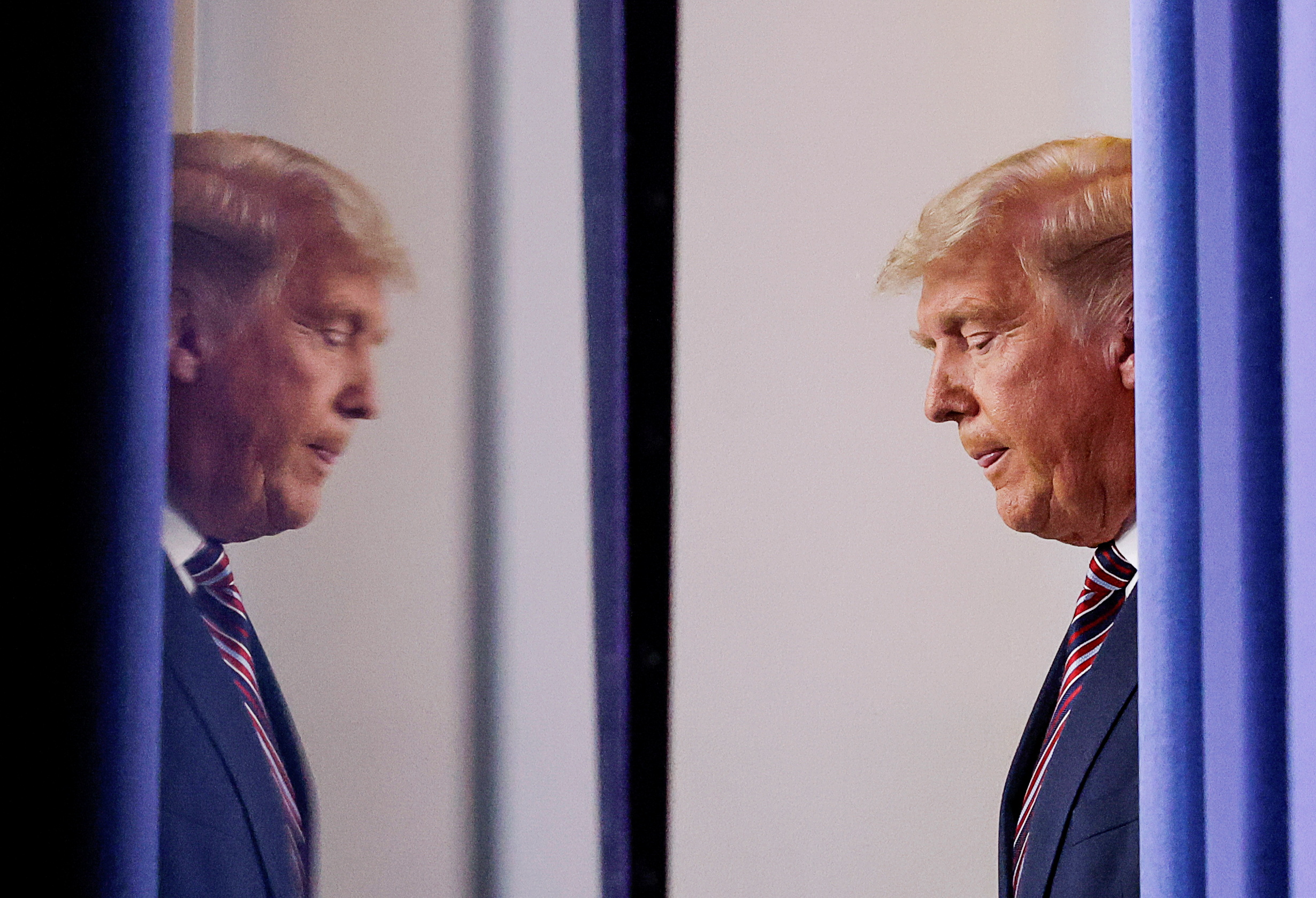 U.S. President Donald Trump is reflected as he arrives to speak about the 2020 U.S. presidential election results in the Brady Press Briefing Room at the White House in Washington, U.S., November 5, 2020. REUTERS/Carlos Barria