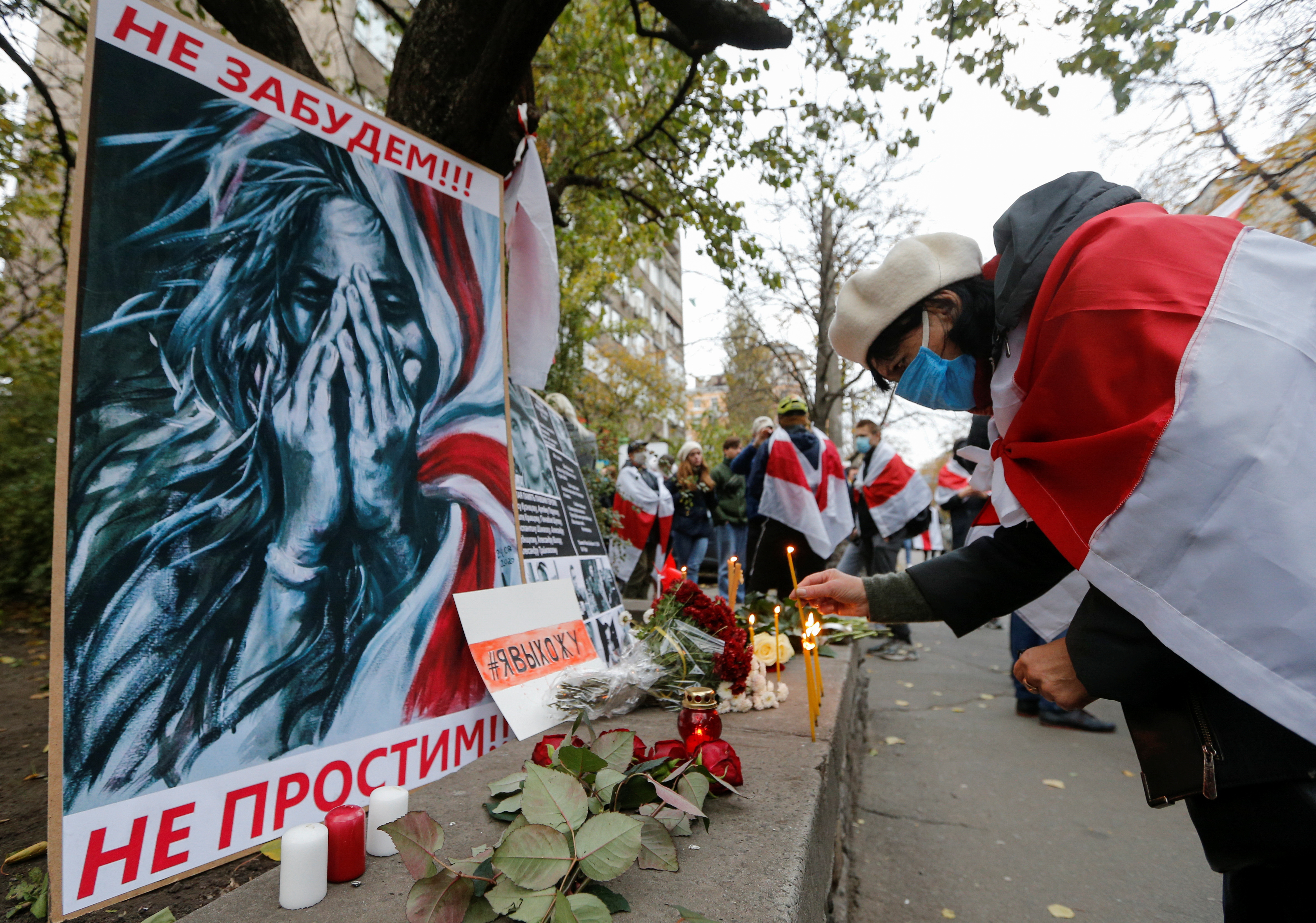 People mourn the death of Belarusian anti-government protester Roman Bondarenko in Kyiv