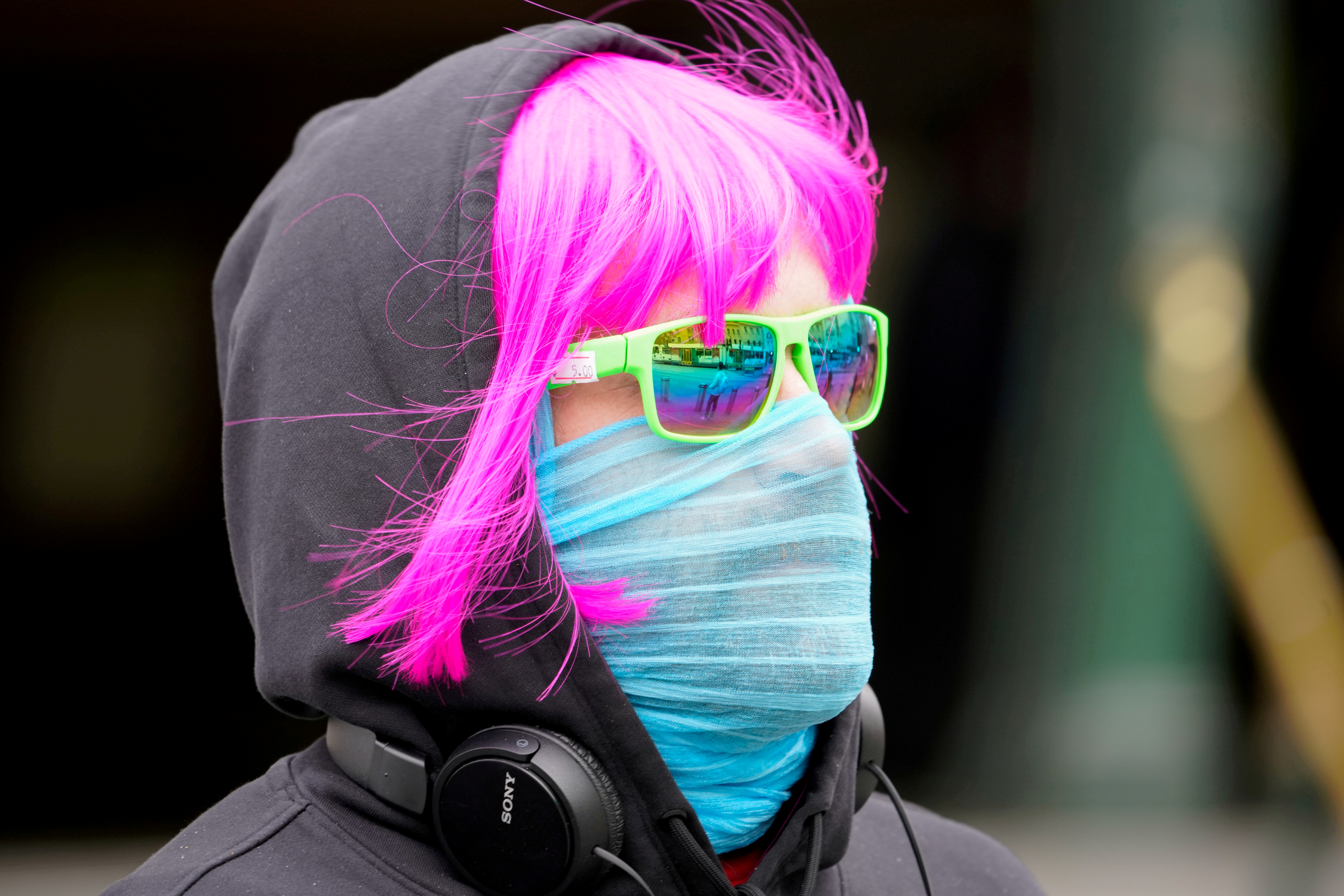 FILE PHOTO: FILE PHOTO: A person wears a scarf as a protective face mask in Melbourne, the first city in Australia to enforce mask-wearing to curb a resurgence of COVID-19