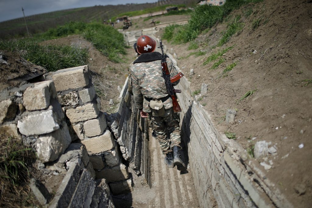 FILE PHOTO: Ethnic Armenian soldiers walk in a trench at their position near Nagorno-Karabakh's boundary, April 8, 2016. REUTERS/Staff/File Photo/File Photo