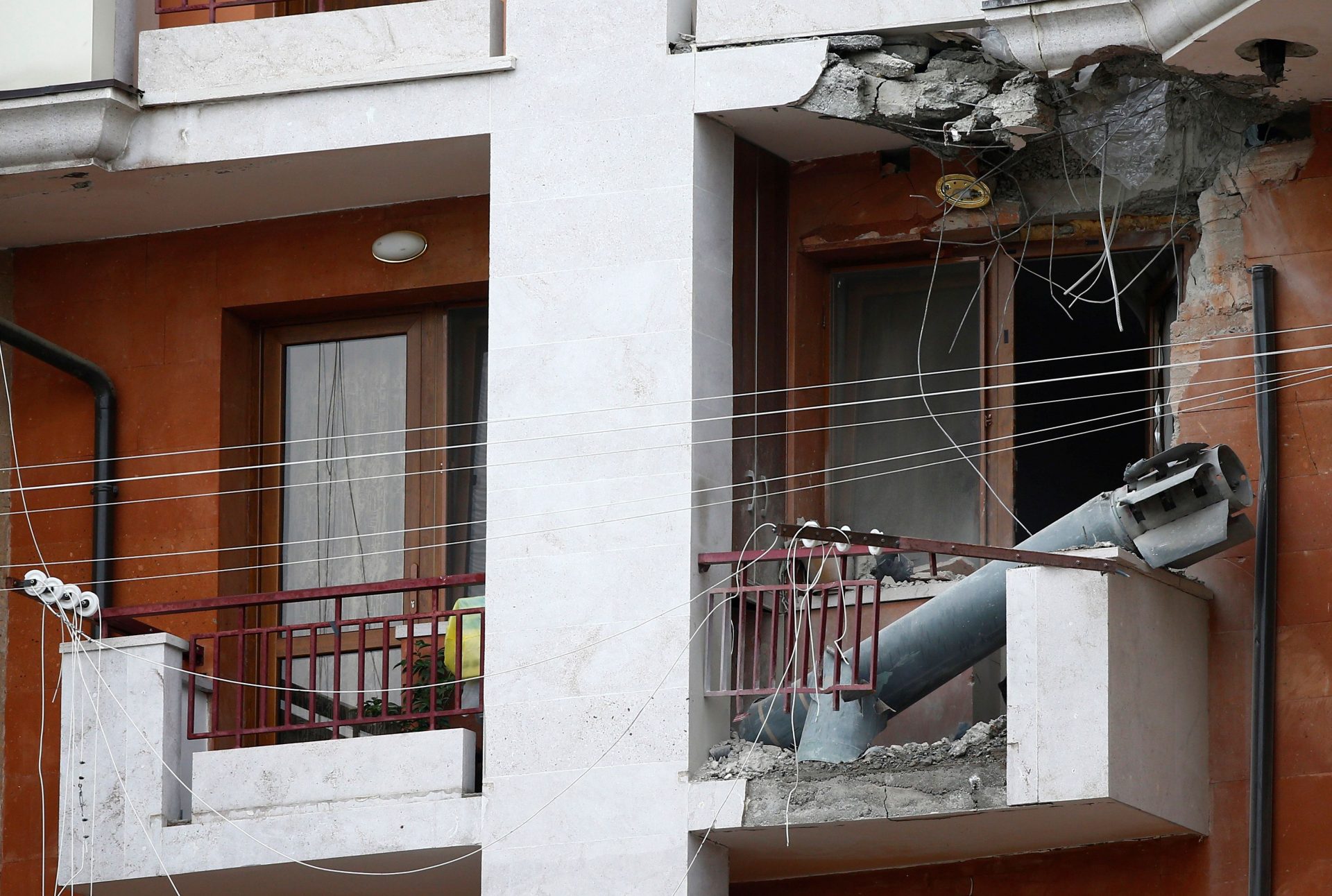 The remains of a rocket shell are seen on the balcony of an apartment building after recent shelling during a military conflict over the breakaway region of Nagorno-Karabakh in Stepanakert October 7, 2020. REUTERS/Stringer