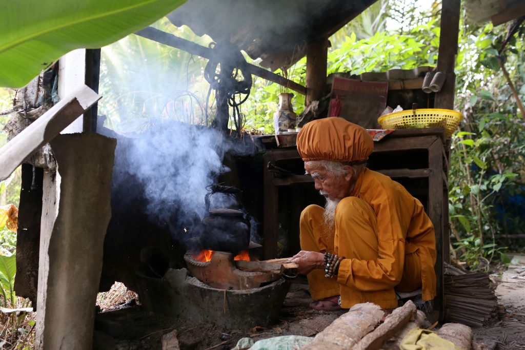 Nguyen Van Chien, 92, sits to cook at his home in Tien Giang province, Vietnam , August 21, 2020. Picture taken August 21, 2020. REUTERS/Yen Doung