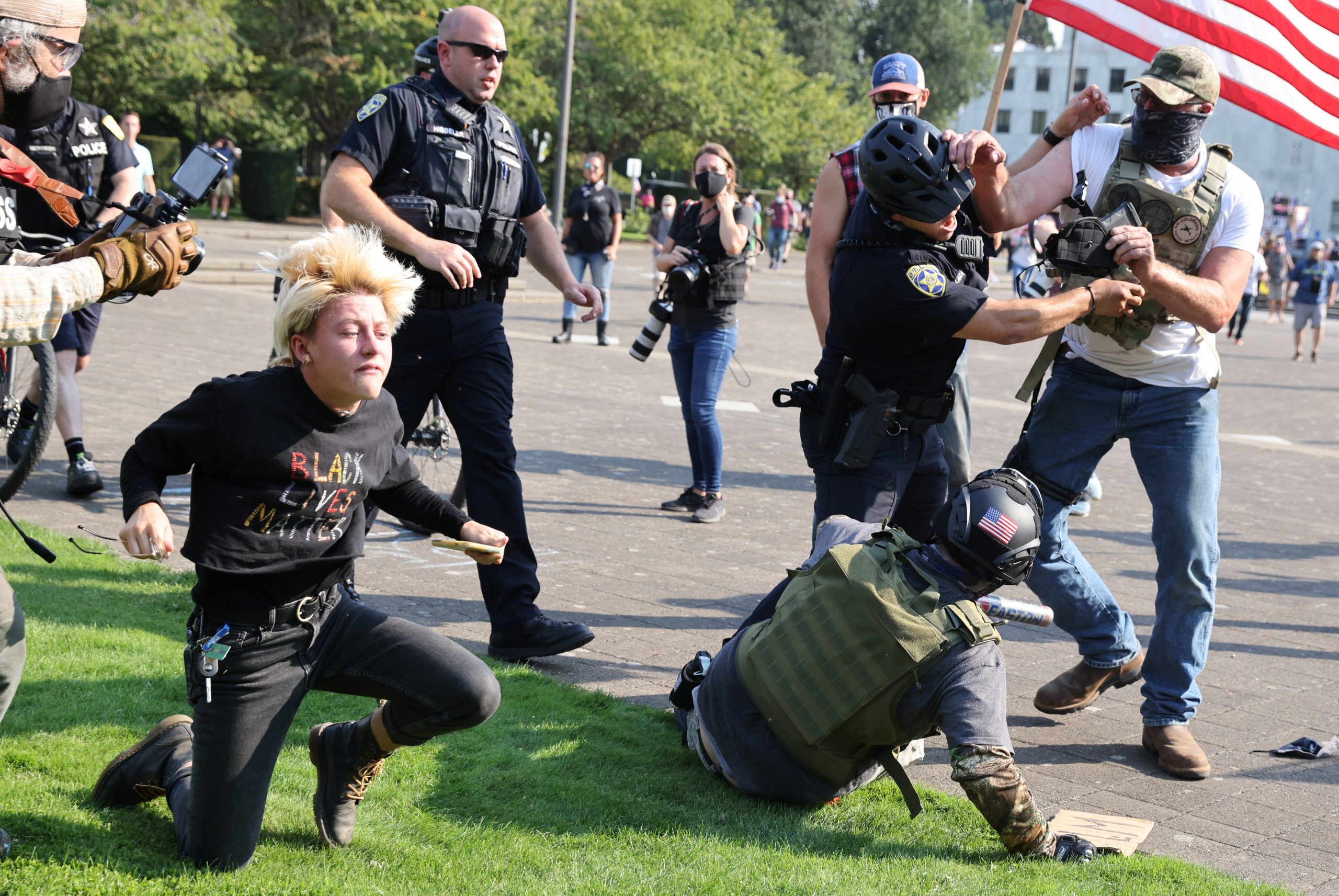 Police officers break up a fight between supporters of U.S. President Donald Trump and Black Lives Matter protesters outside the Oregon State Capitol building in Salem, Oregon, U.S. September 7, 2020. REUTERS/Carlos Barria