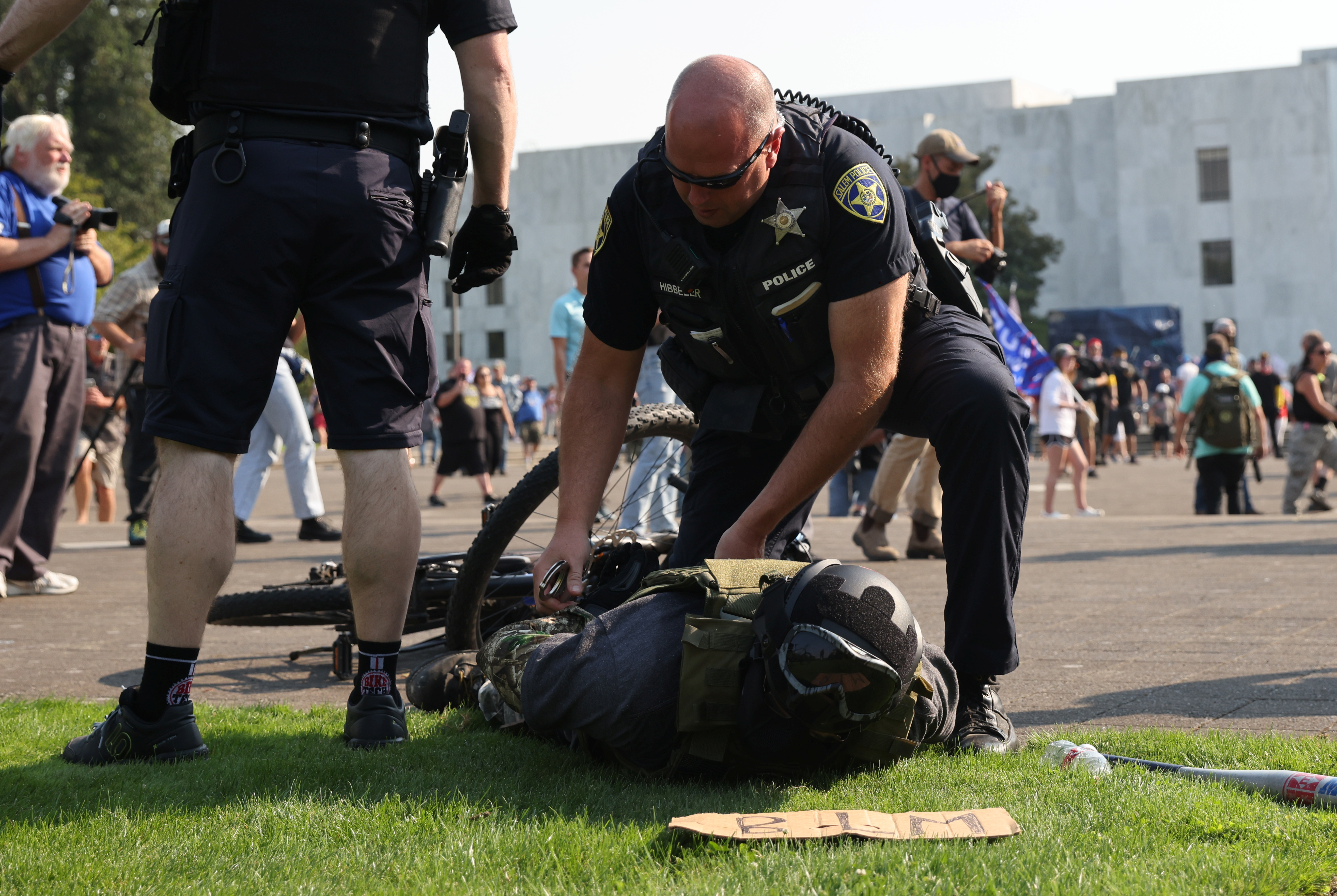 Police officers detain a supporter of U.S. President Donald Trump following a scuffle with Black Lives Matter protesters outside the Oregon State Capitol building in Salem, Oregon, U.S. September 7, 2020. REUTERS/Carlos Barria