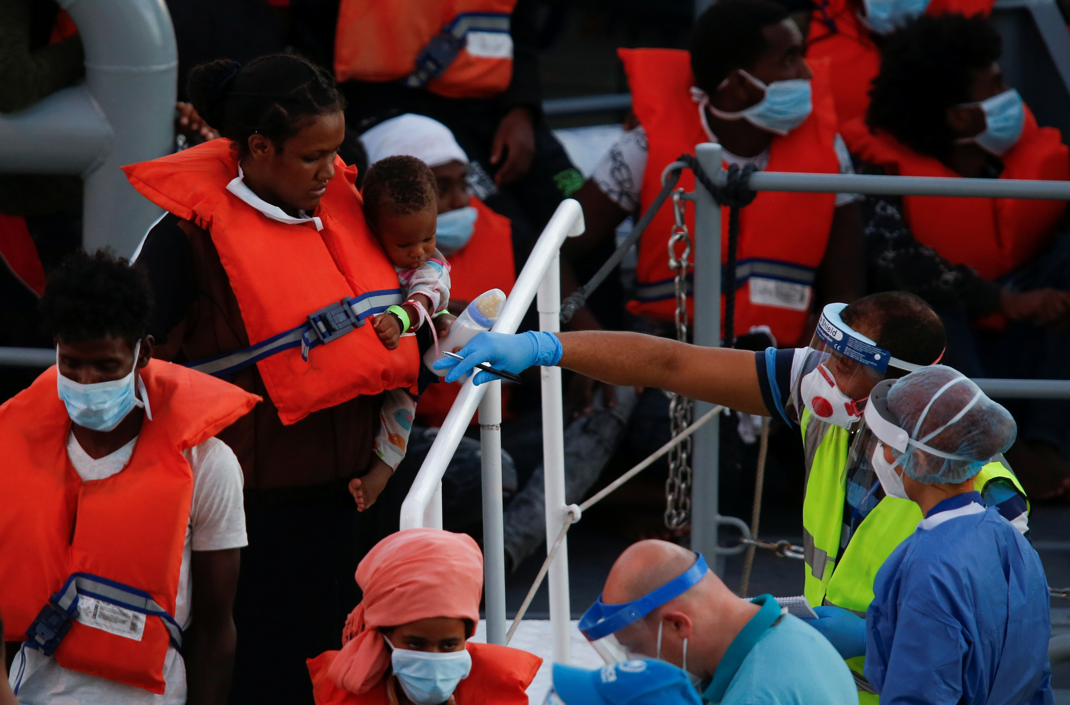 Rescued migrants disembark during their arrival in Senglea, in Valletta's Grand Harbour, as the coronavirus disease (COVID-19) outbreak continues, Malta July 27, 2020. REUTERS/Darrin Zammit Lupi